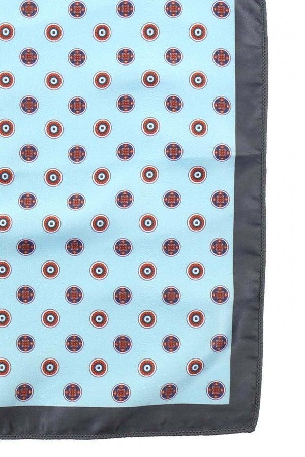 Light blue pocket square with repeating red circular pattern and dark border