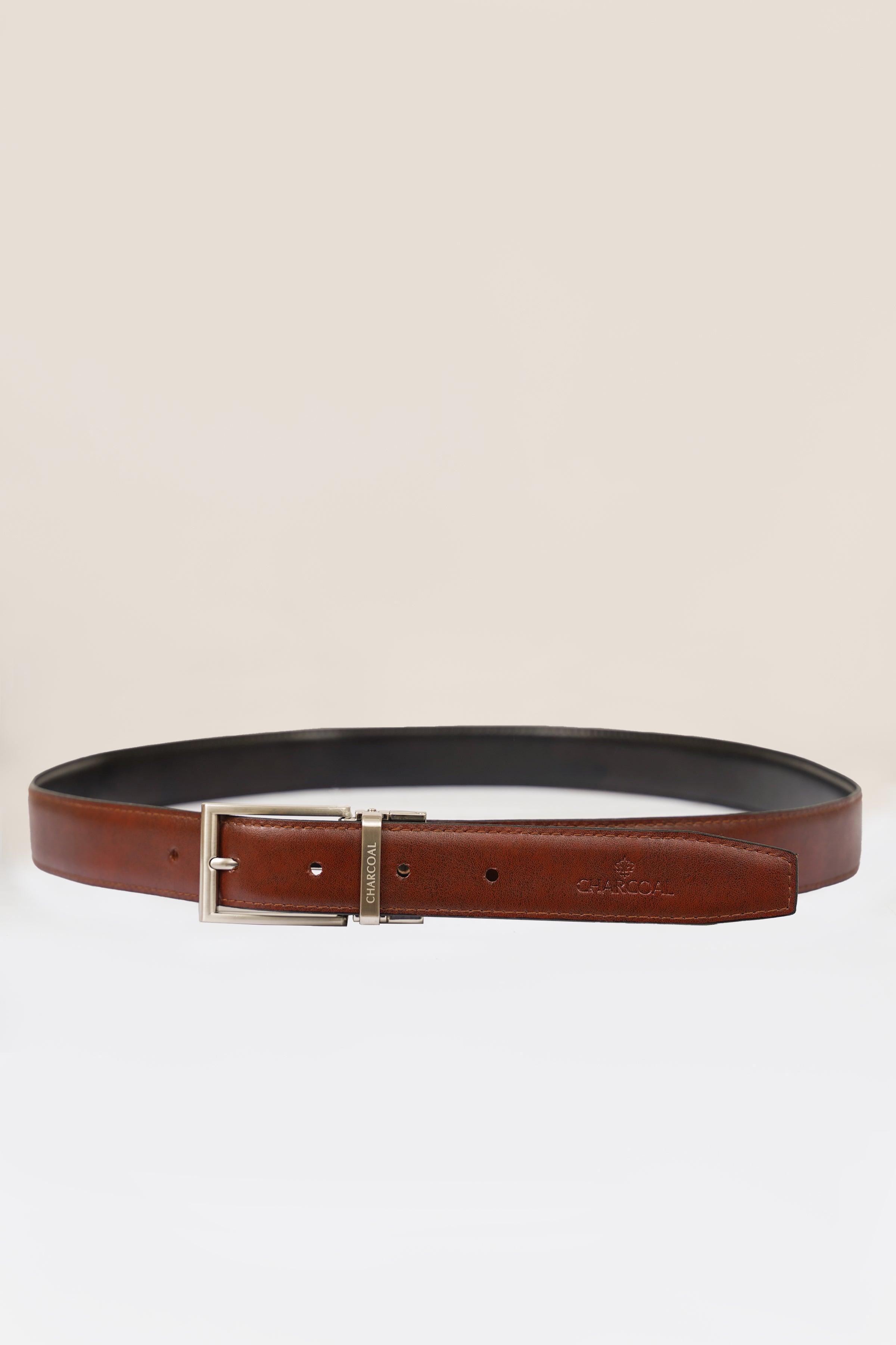 Reversible belt with silver buckle; brown leather side with punched holes