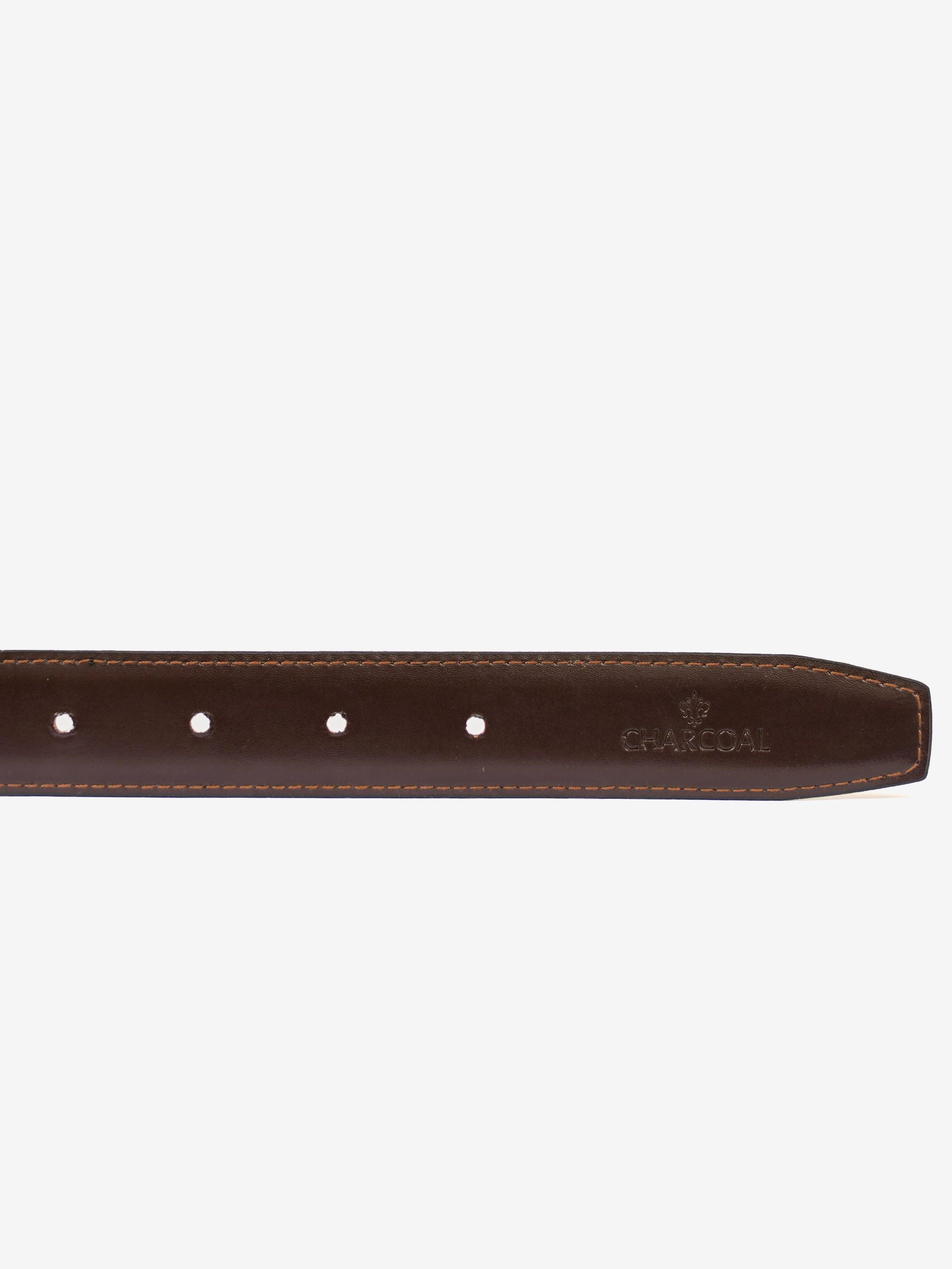 Reversible belt close-up: brown leather strap with metal holes and embossed logo detail.