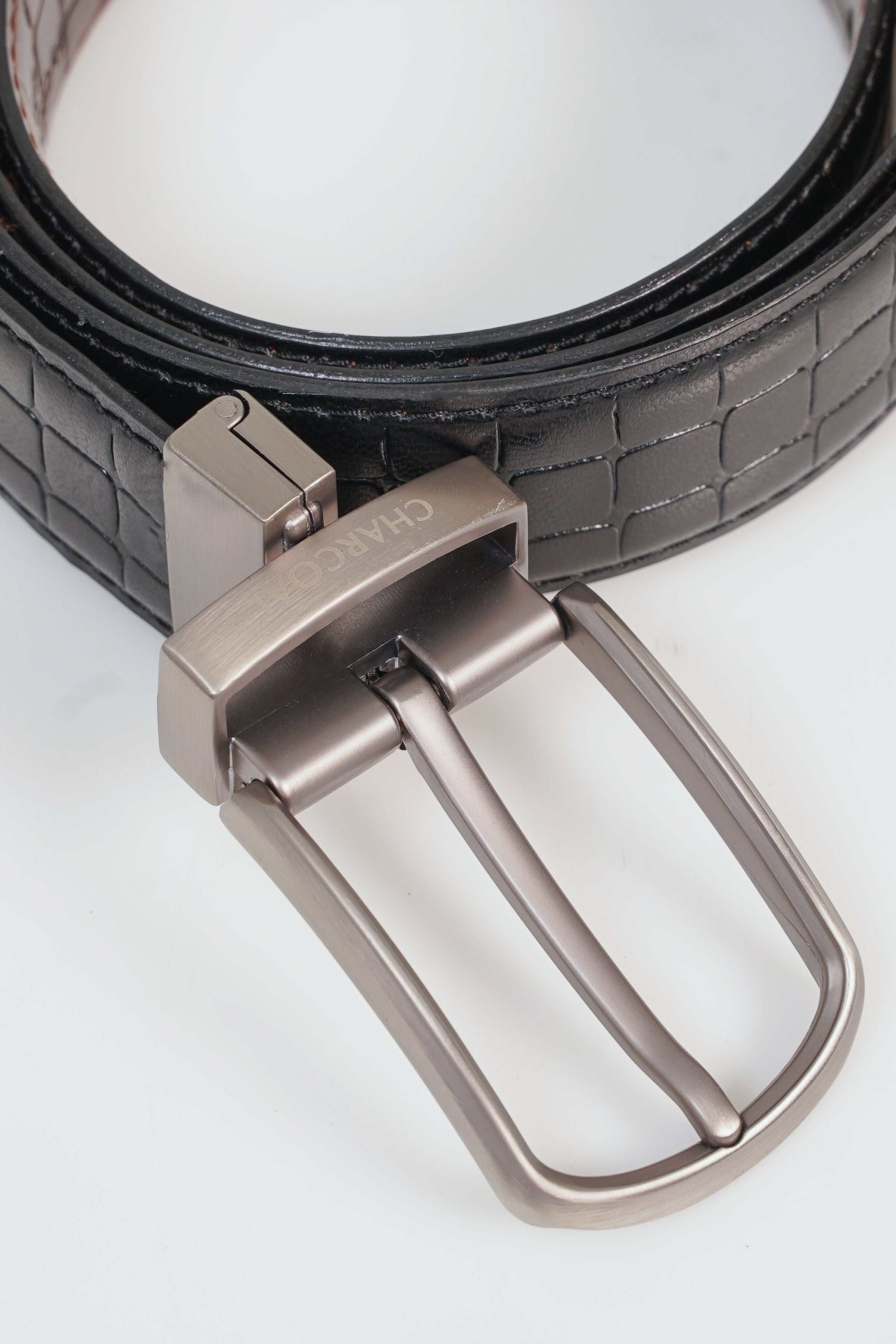 Reversible belt close-up with silver metal buckle and dark strap