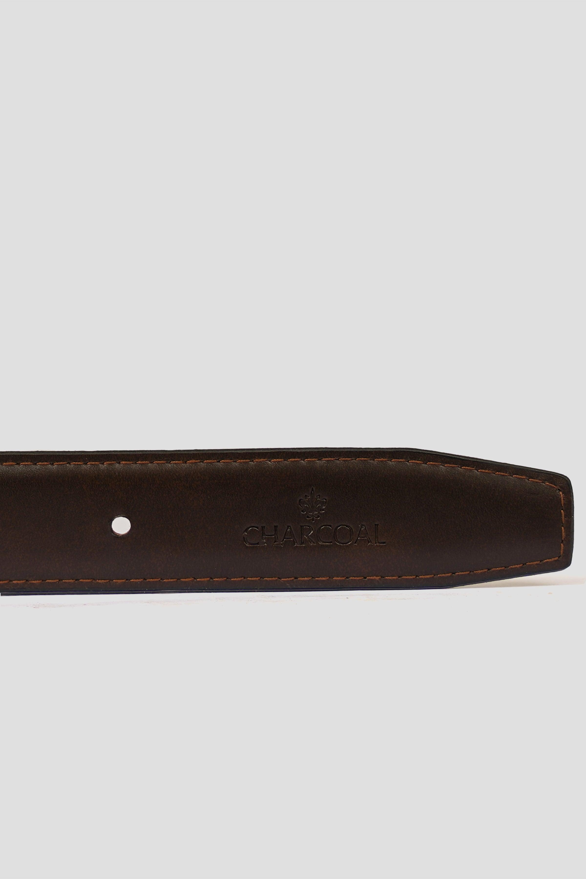 Reversible leather belt close-up: embossed logo and contrast stitching on band