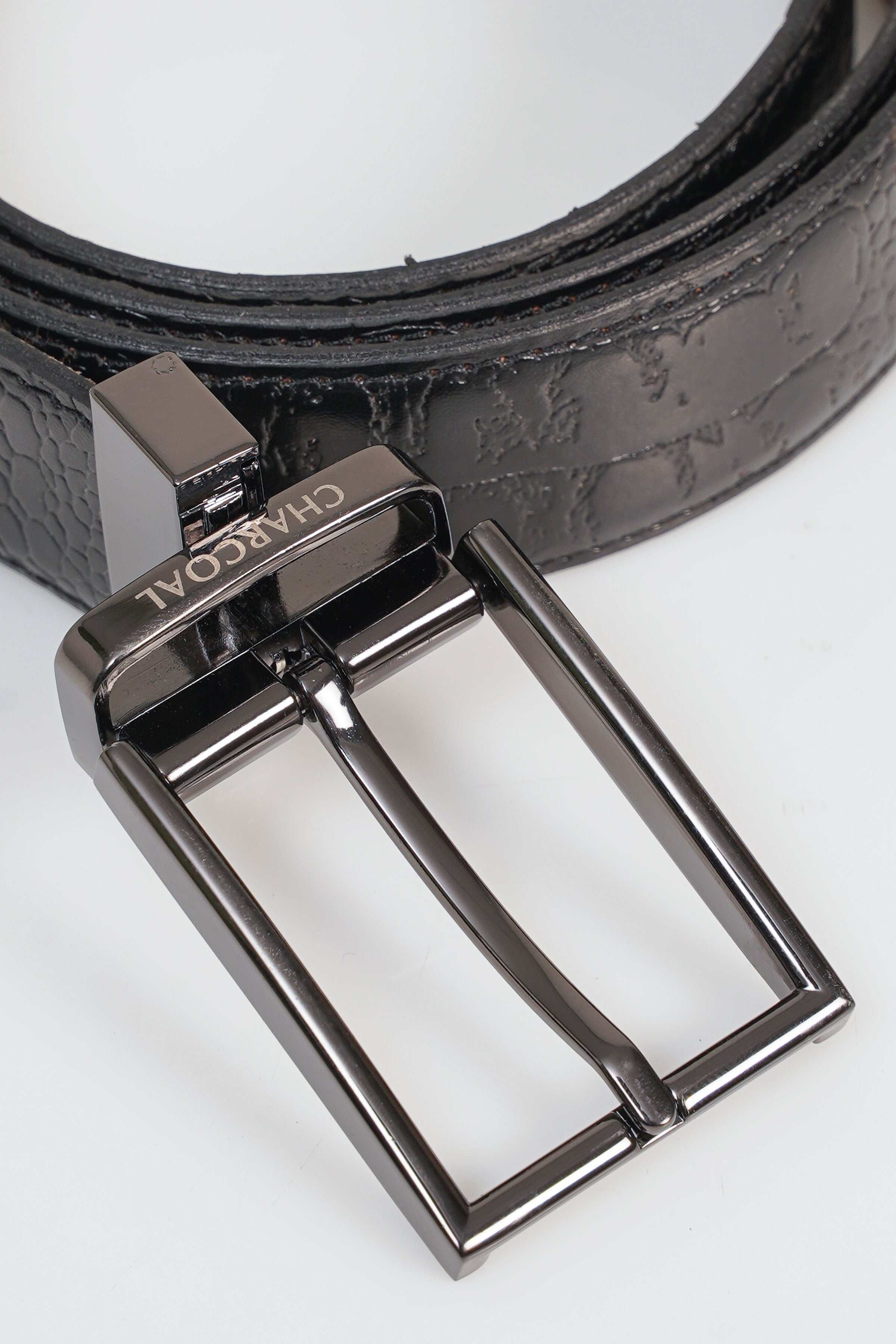 Reversible belt buckle detail with metal prongs and textured dark strap