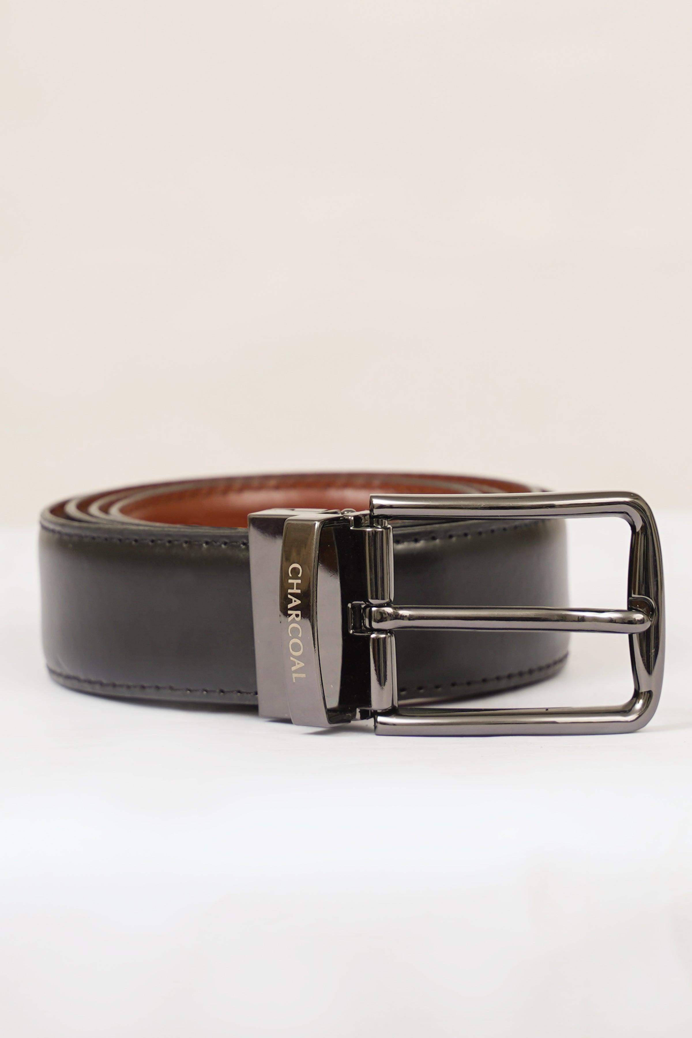Reversible belt with silver pin buckle, dark strap with tan lining and stitched edge.