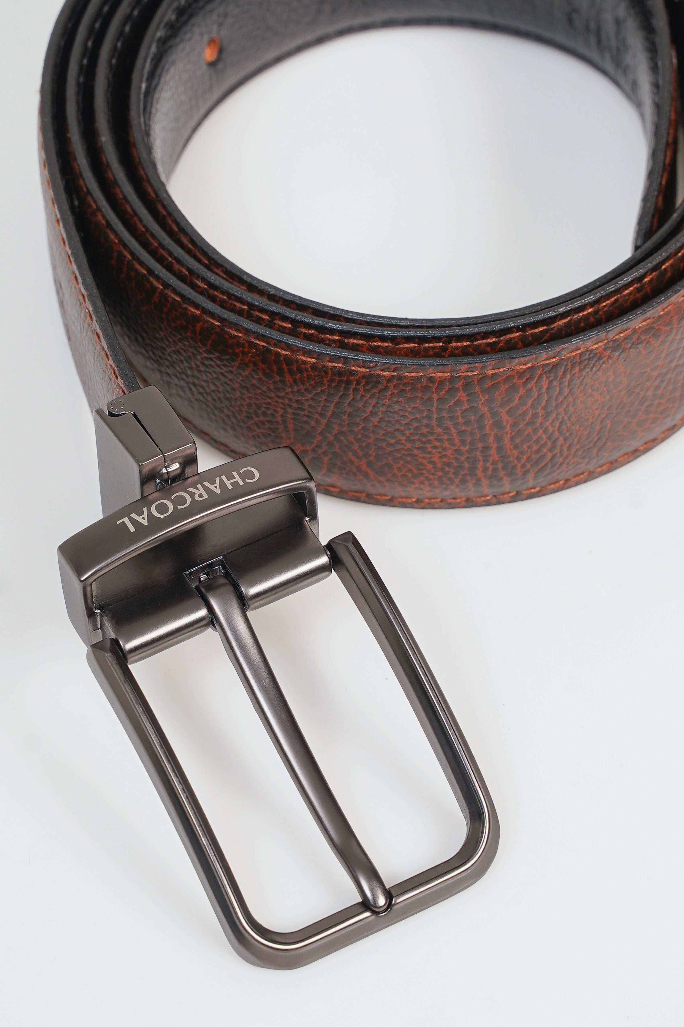 Reversible belt with brown leather and dark underside, metal buckle