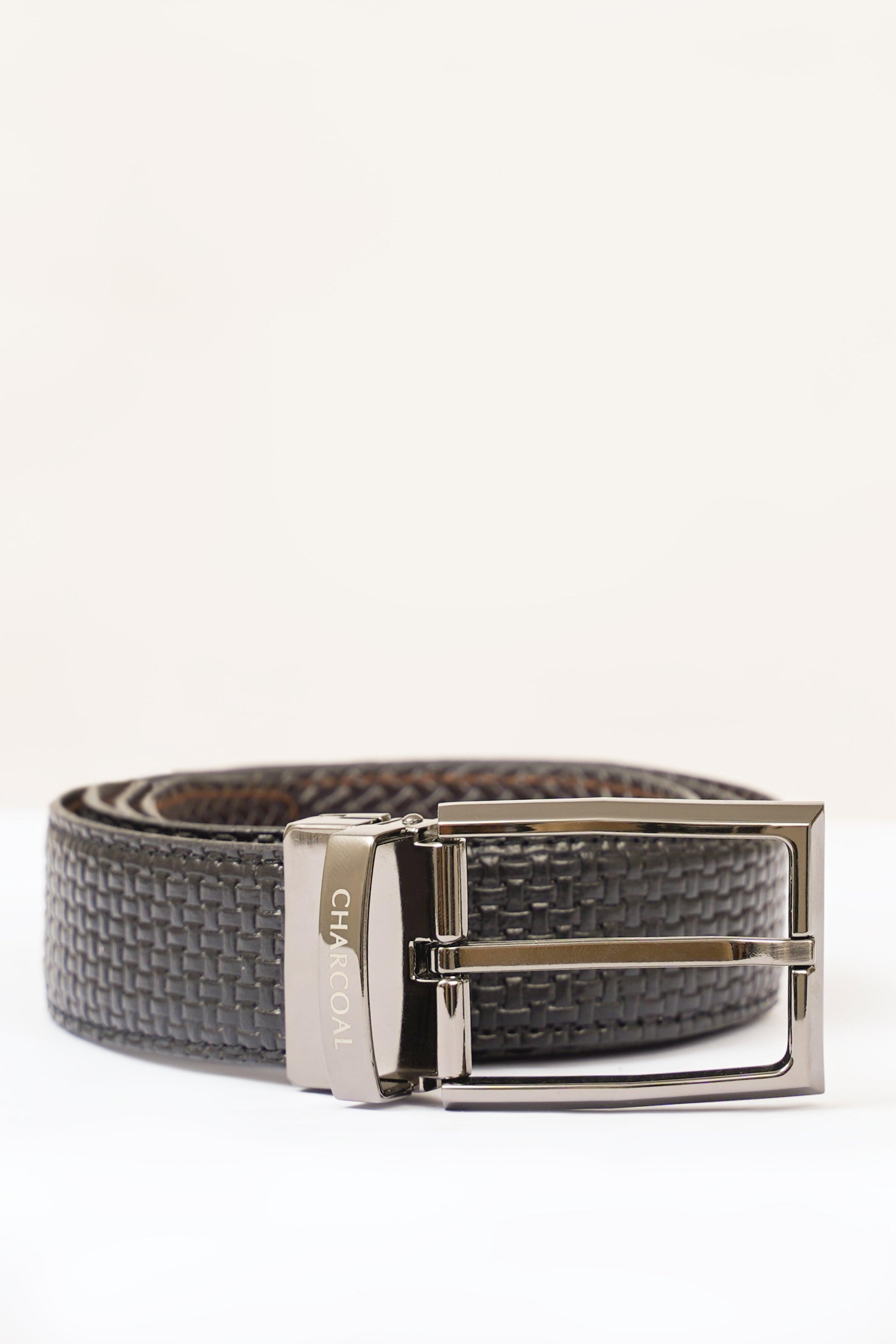 Reversible belt with silver buckle on dark woven strap and keeper
