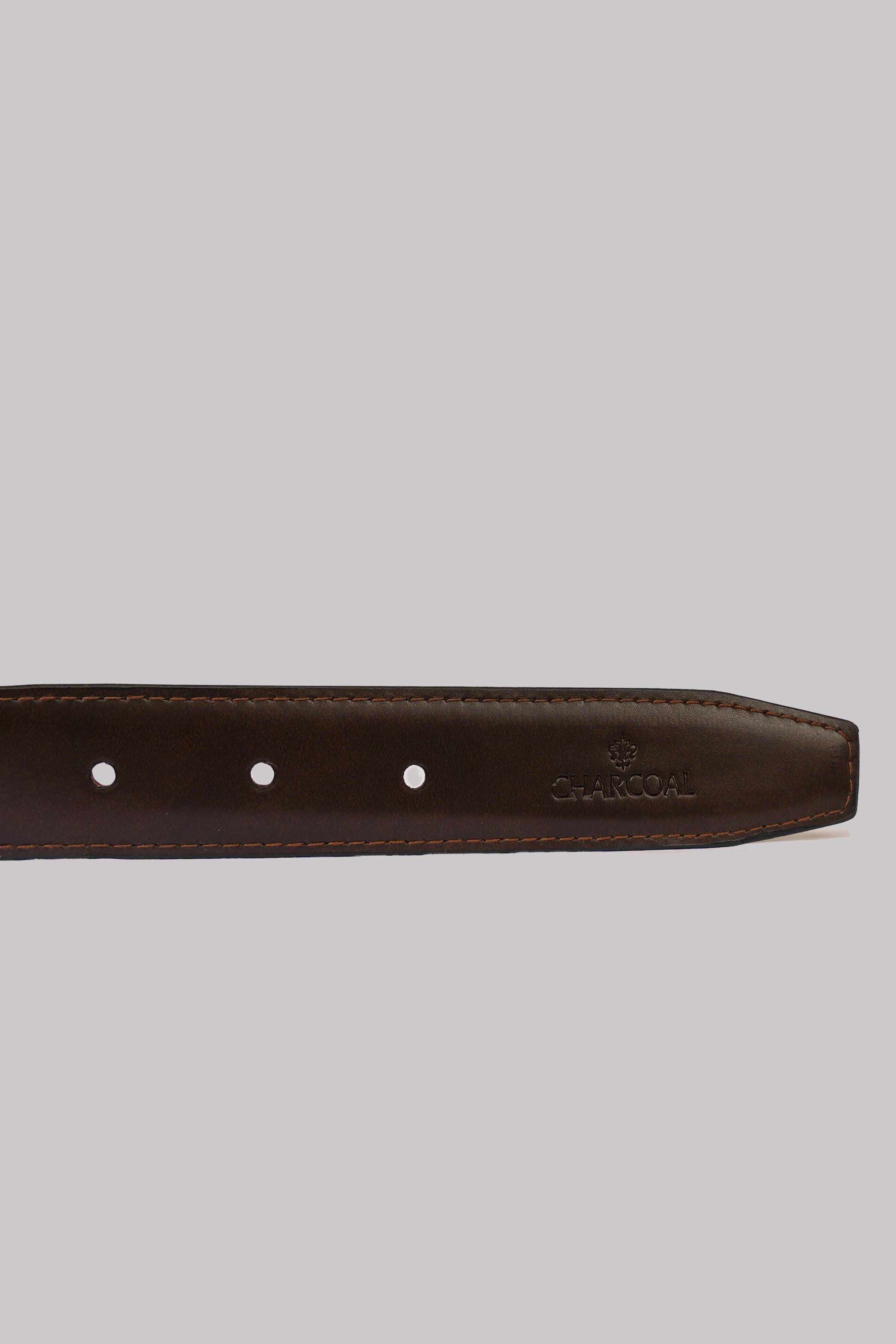 Reversible belt strap detail with punched holes and small logo near edge.