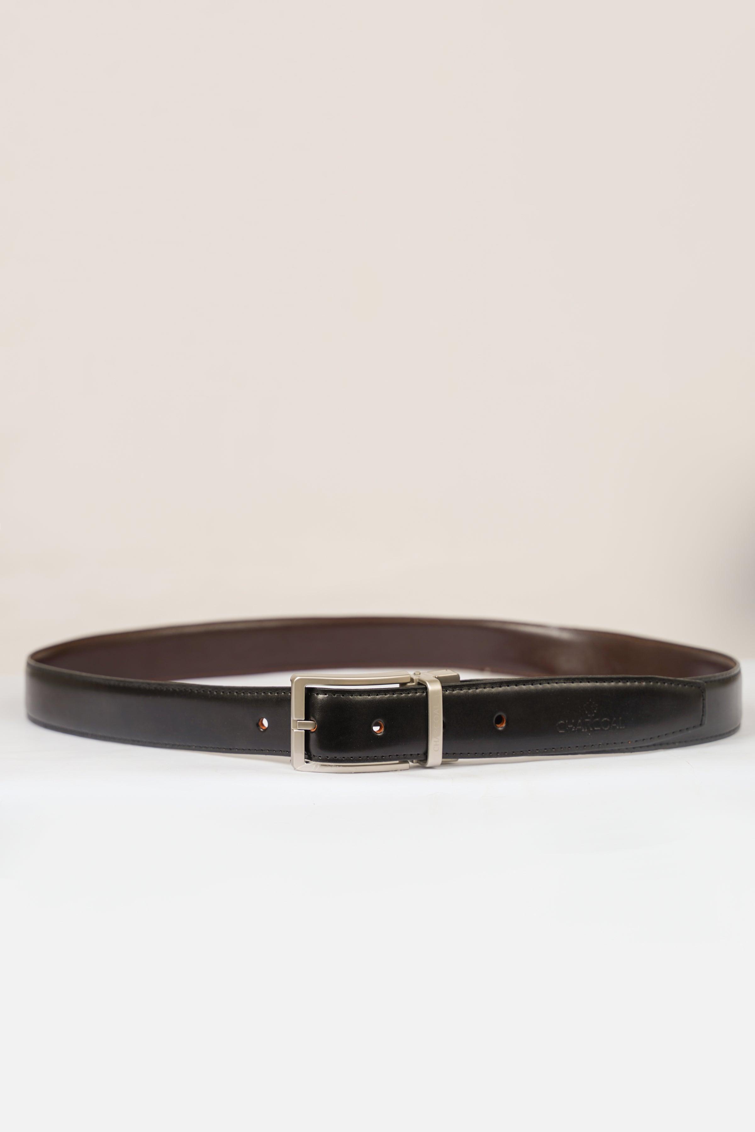 Reversible belt with dark leather strap and silver buckle, with punched holes