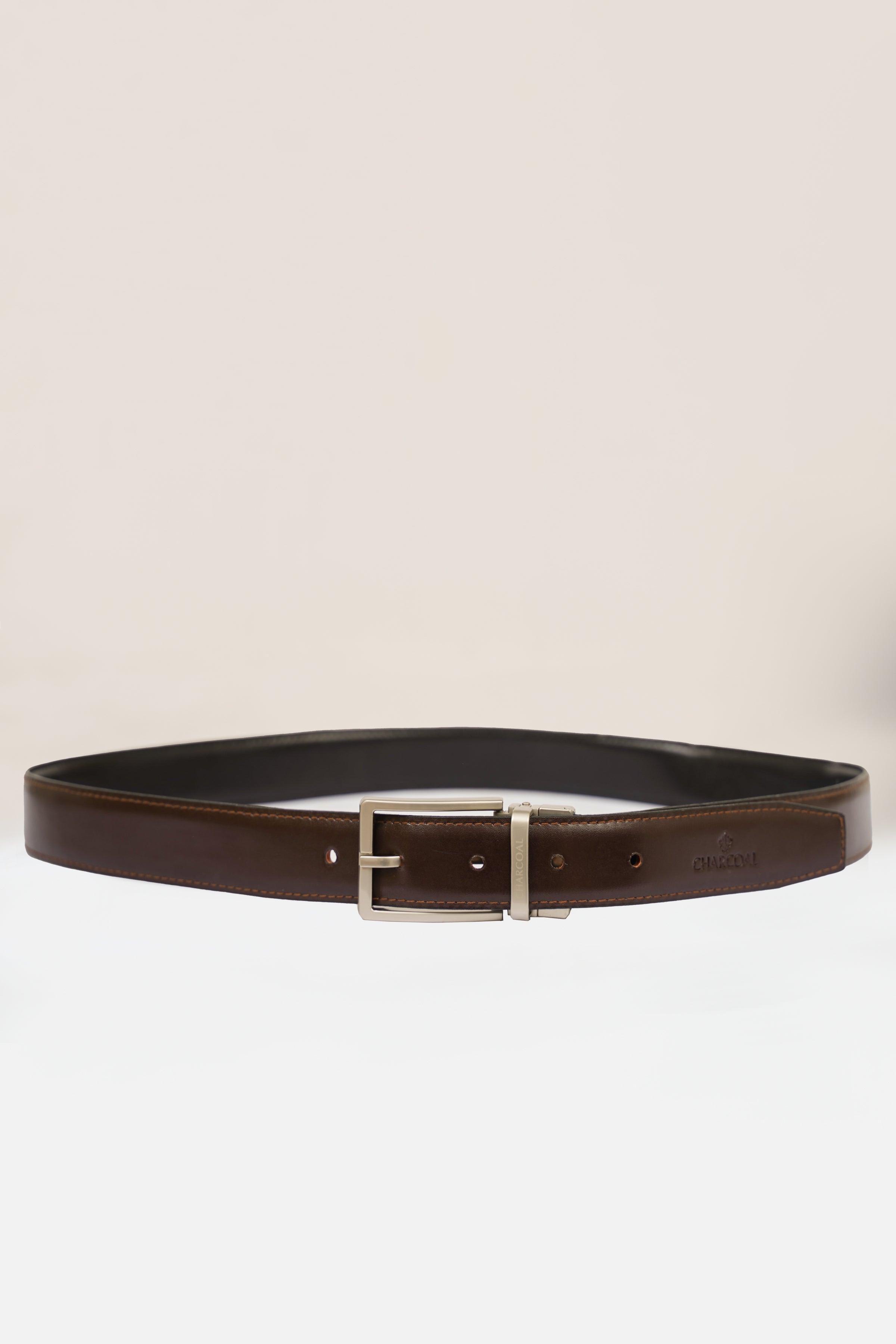 Reversible belt with dark side and silver buckle, showing punched hole line