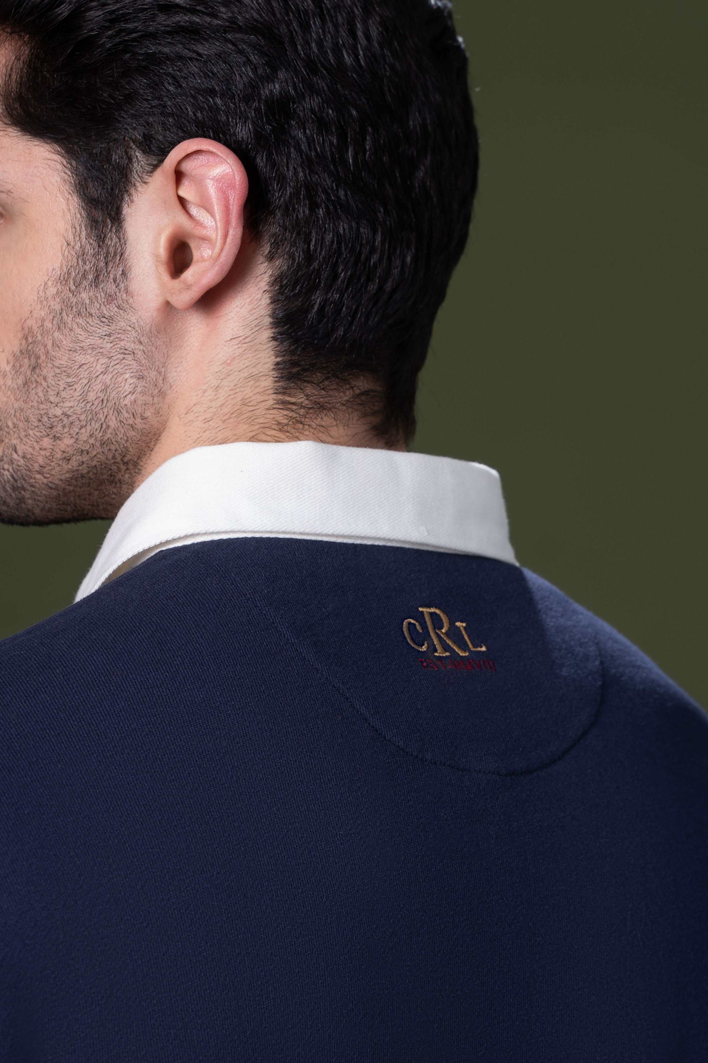 Navy rugby polo shirt neck and CRL logo detail, white collar