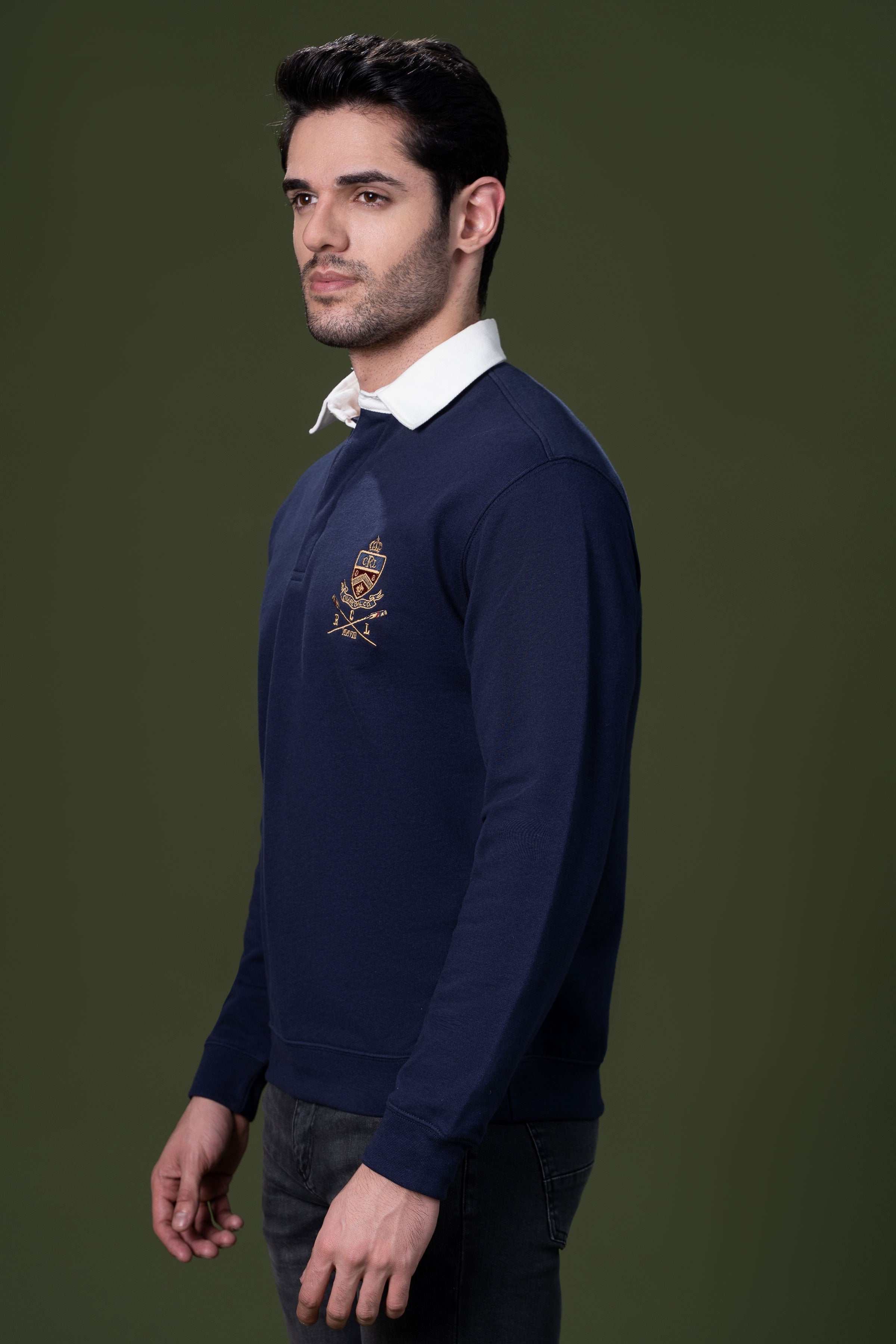 Navy rugby polo shirt, side view with white collar and chest crest
