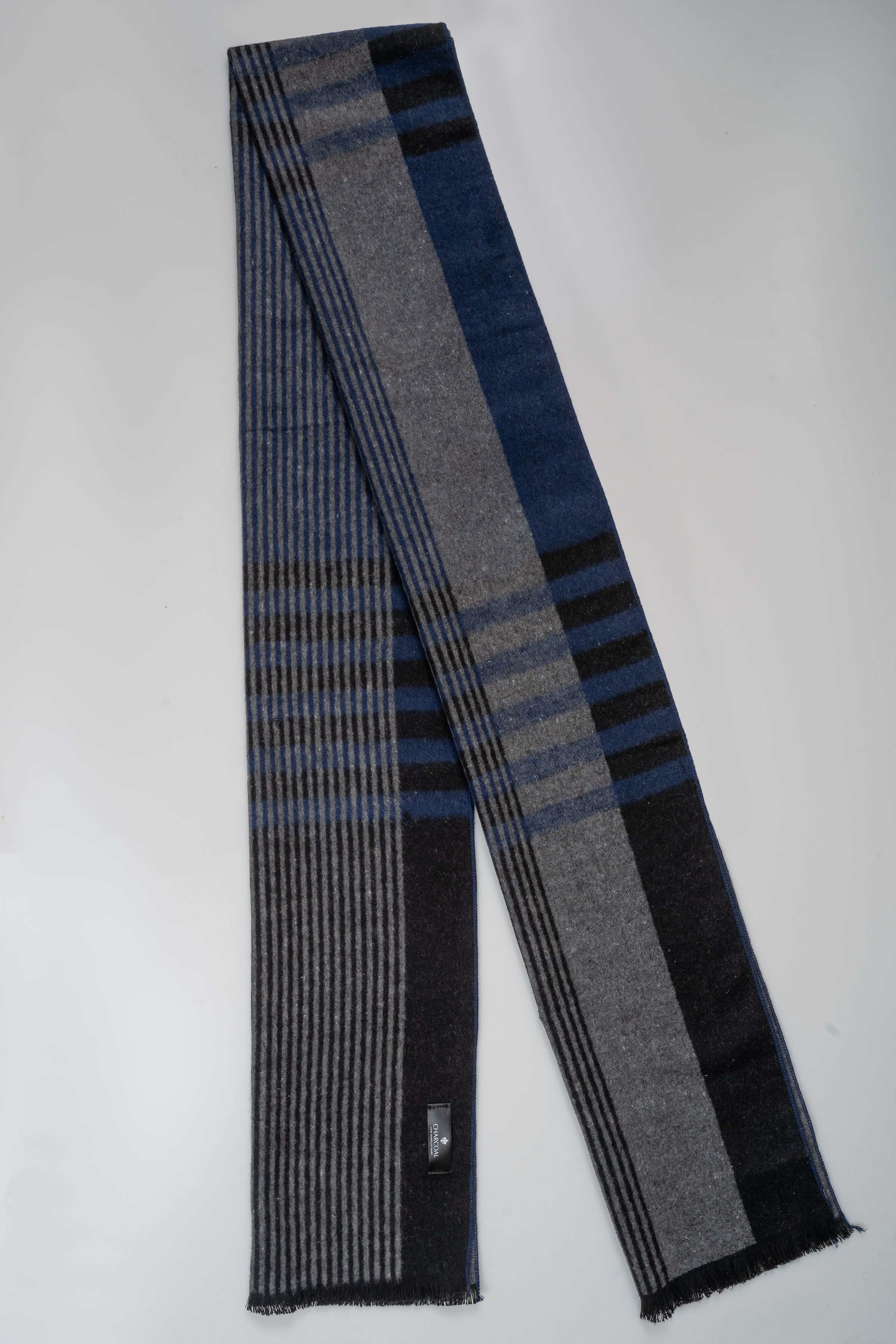 Long plaid scarf in dark gray and blue with vertical stripe blocks and fringe edges.