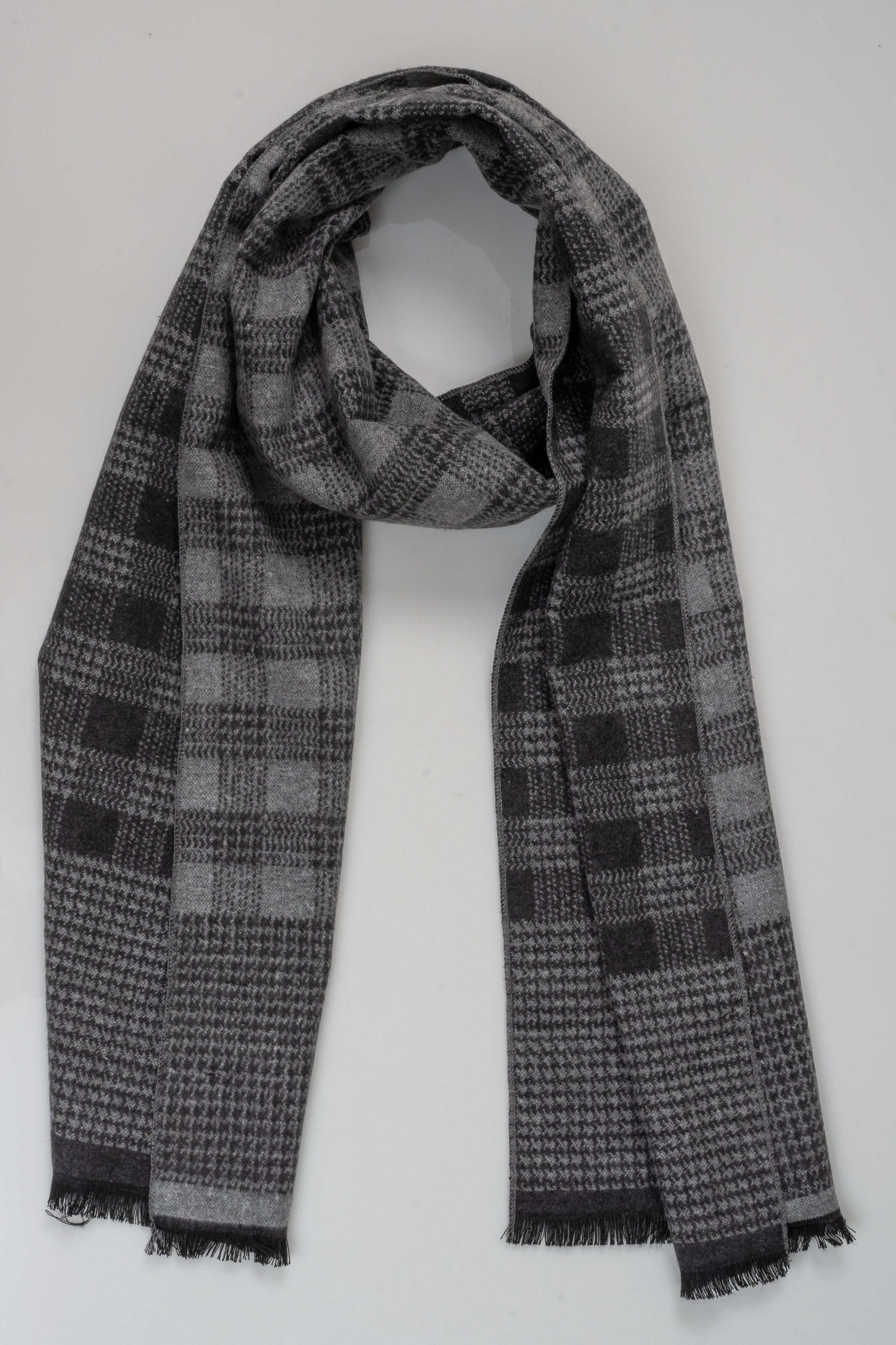 Plaid scarf in dark gray and light gray checks with fringed trim, draped