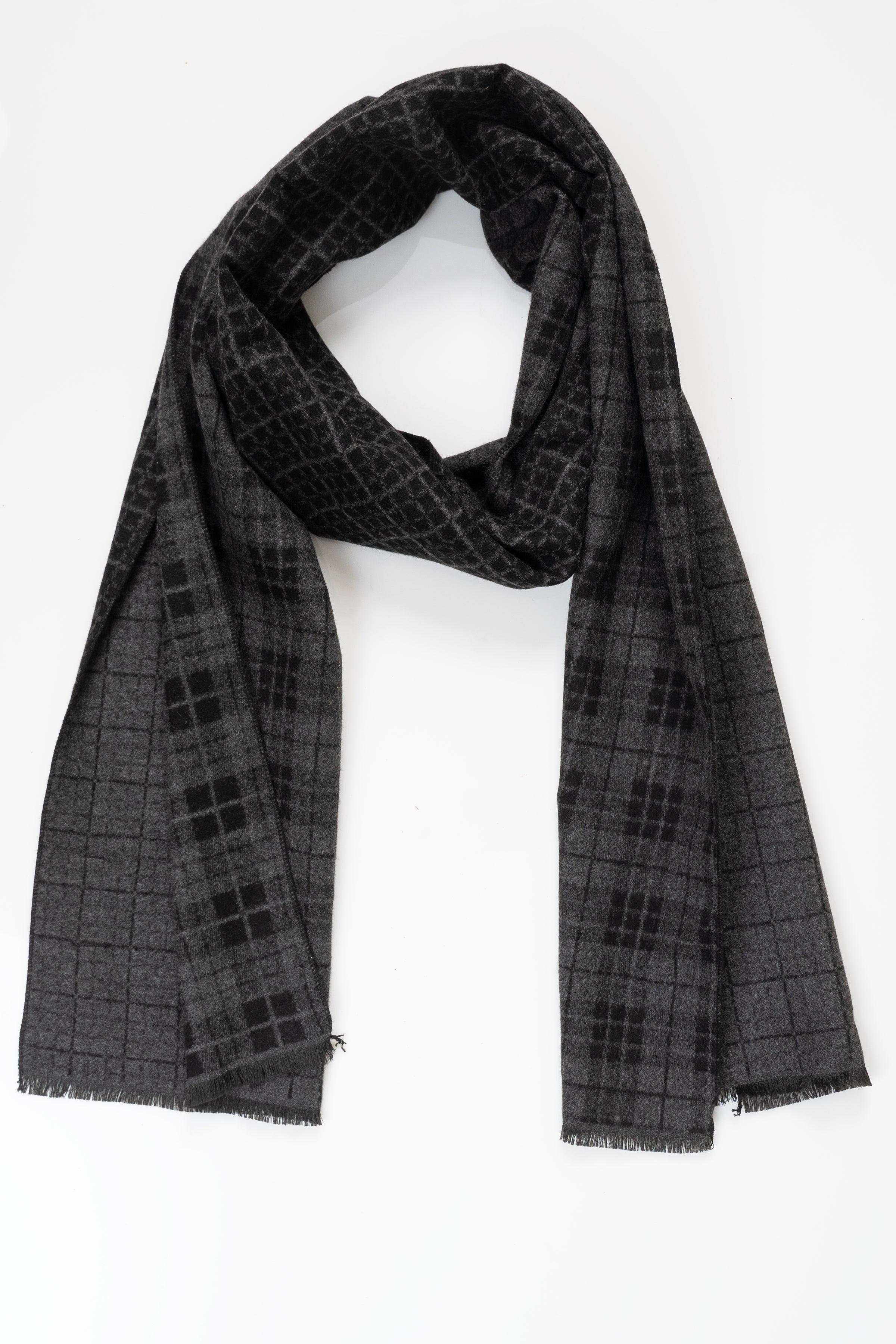 Dark charcoal check-pattern scarf with fringed ends, draped in a loop.
