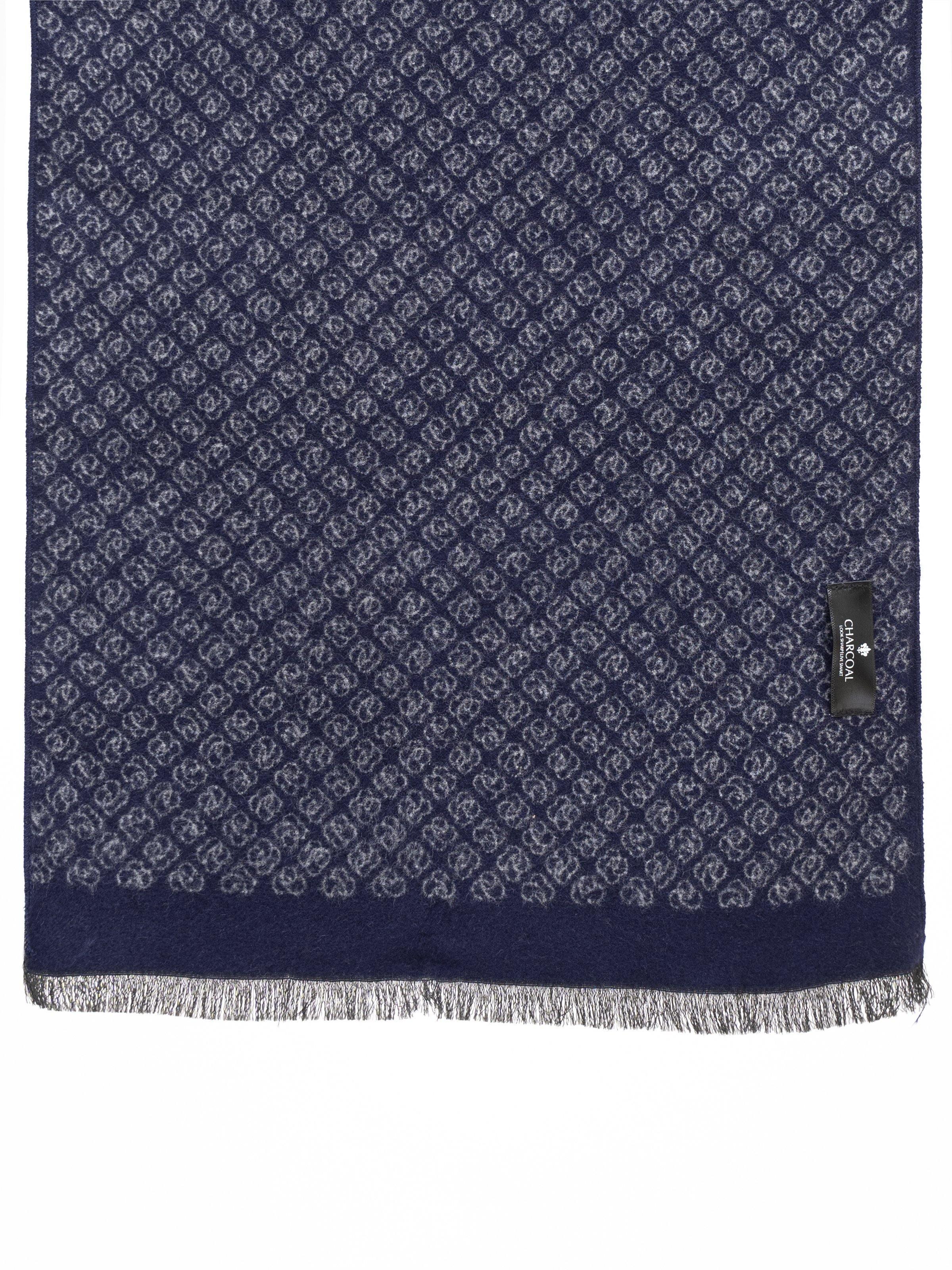 Navy patterned scarf with fringed hem and small logo tag at the edge.