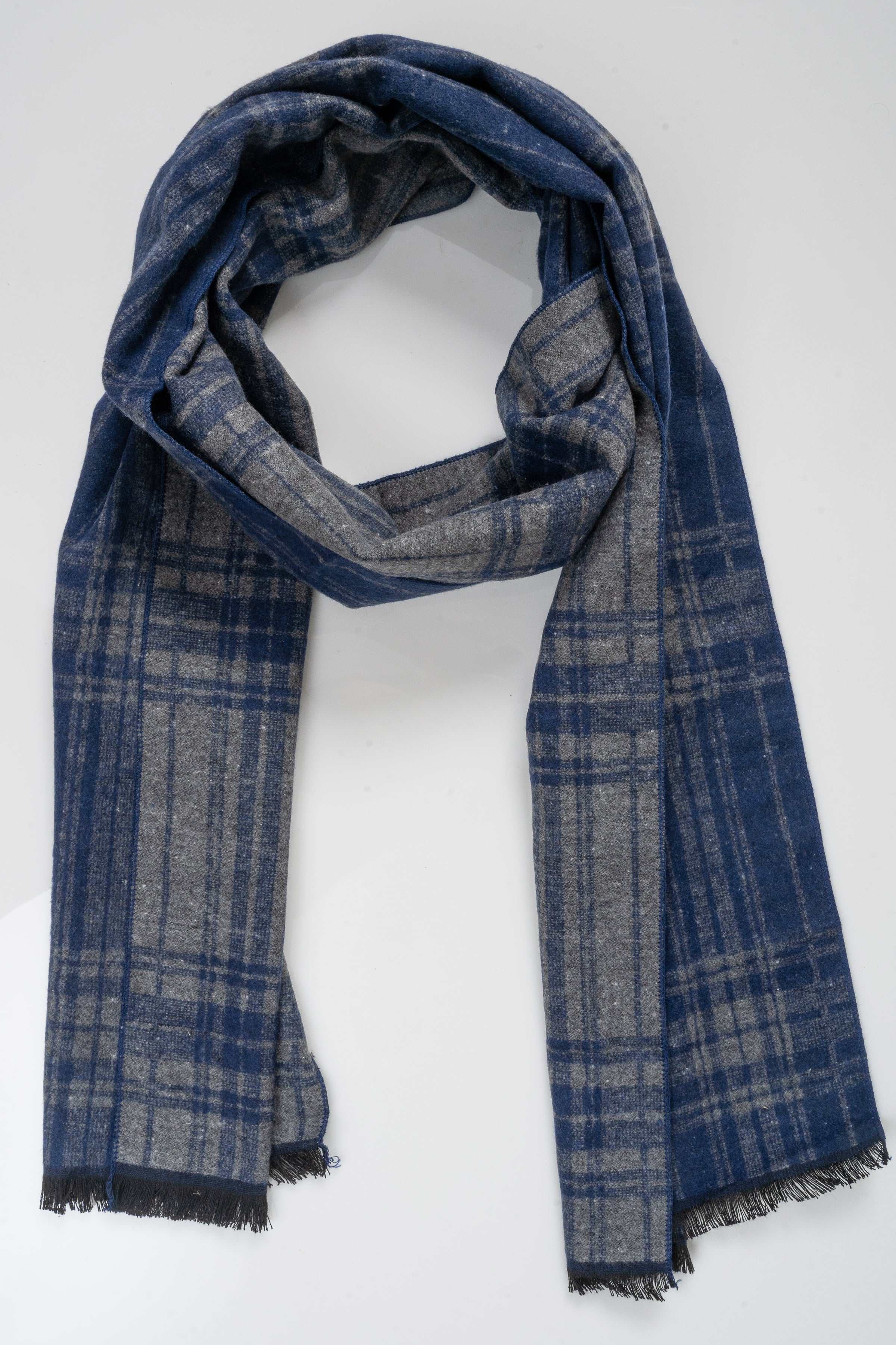 Blue plaid scarf draped in a loop, with fringed ends