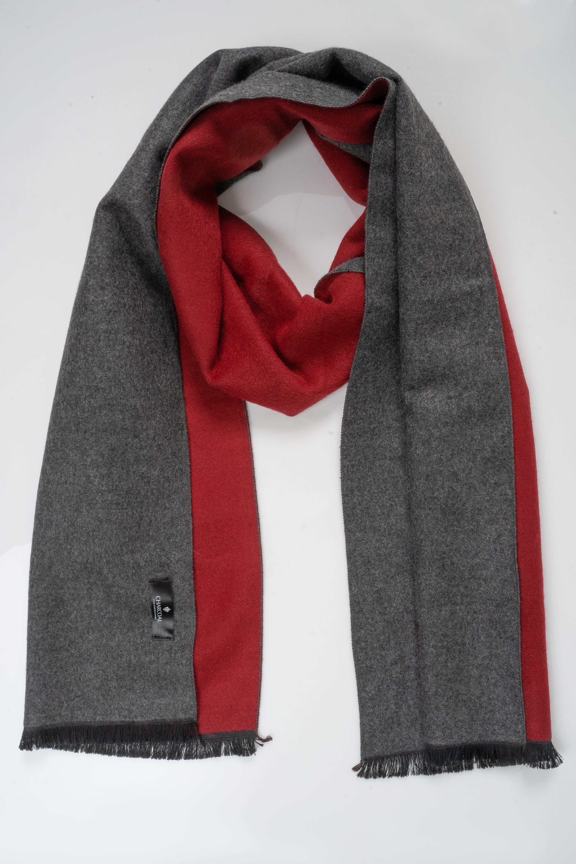 Charcoal gray scarf with red inner panel and frayed ends