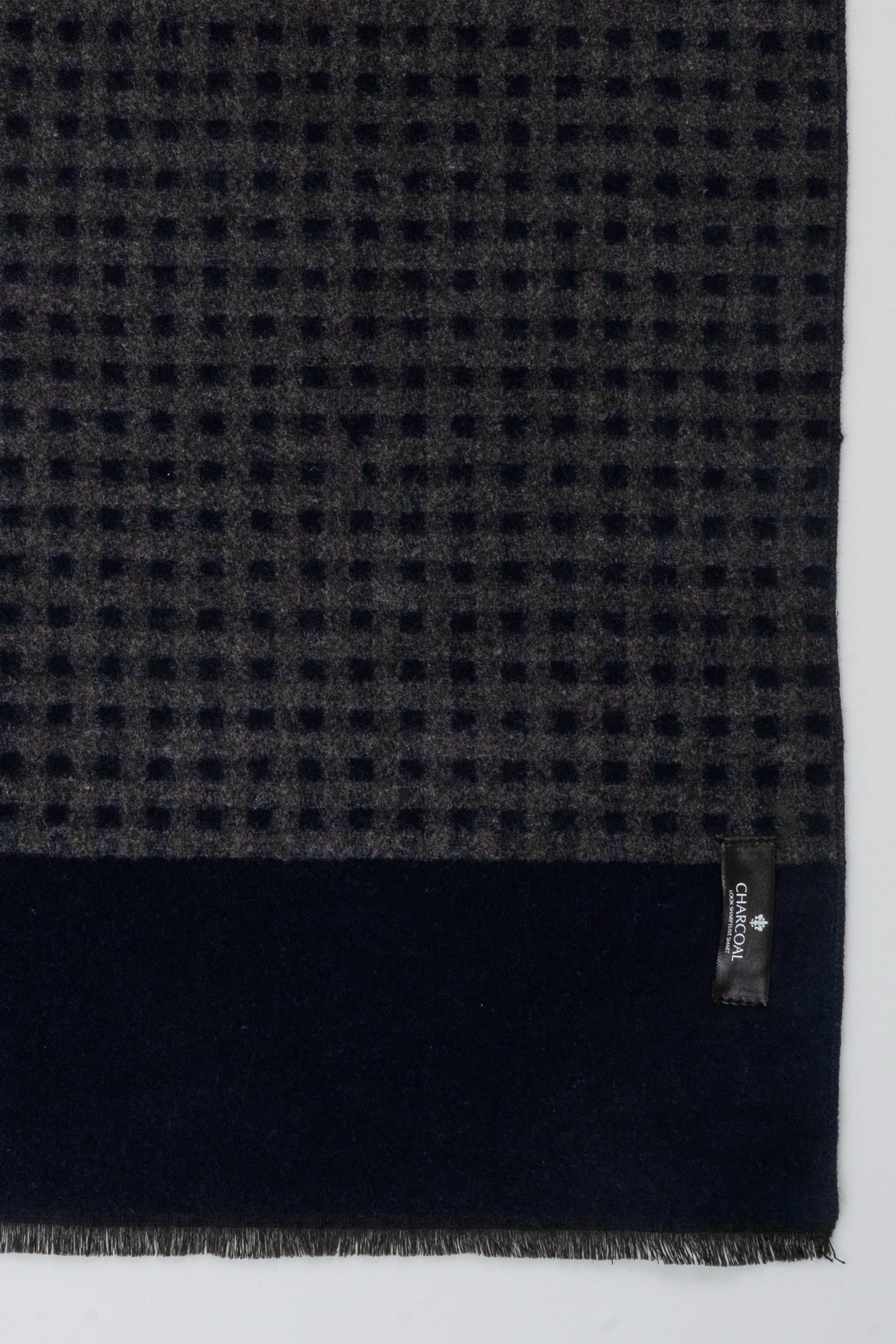 Textured dark blue scarf with small check pattern, frayed ends, brand label on hem.