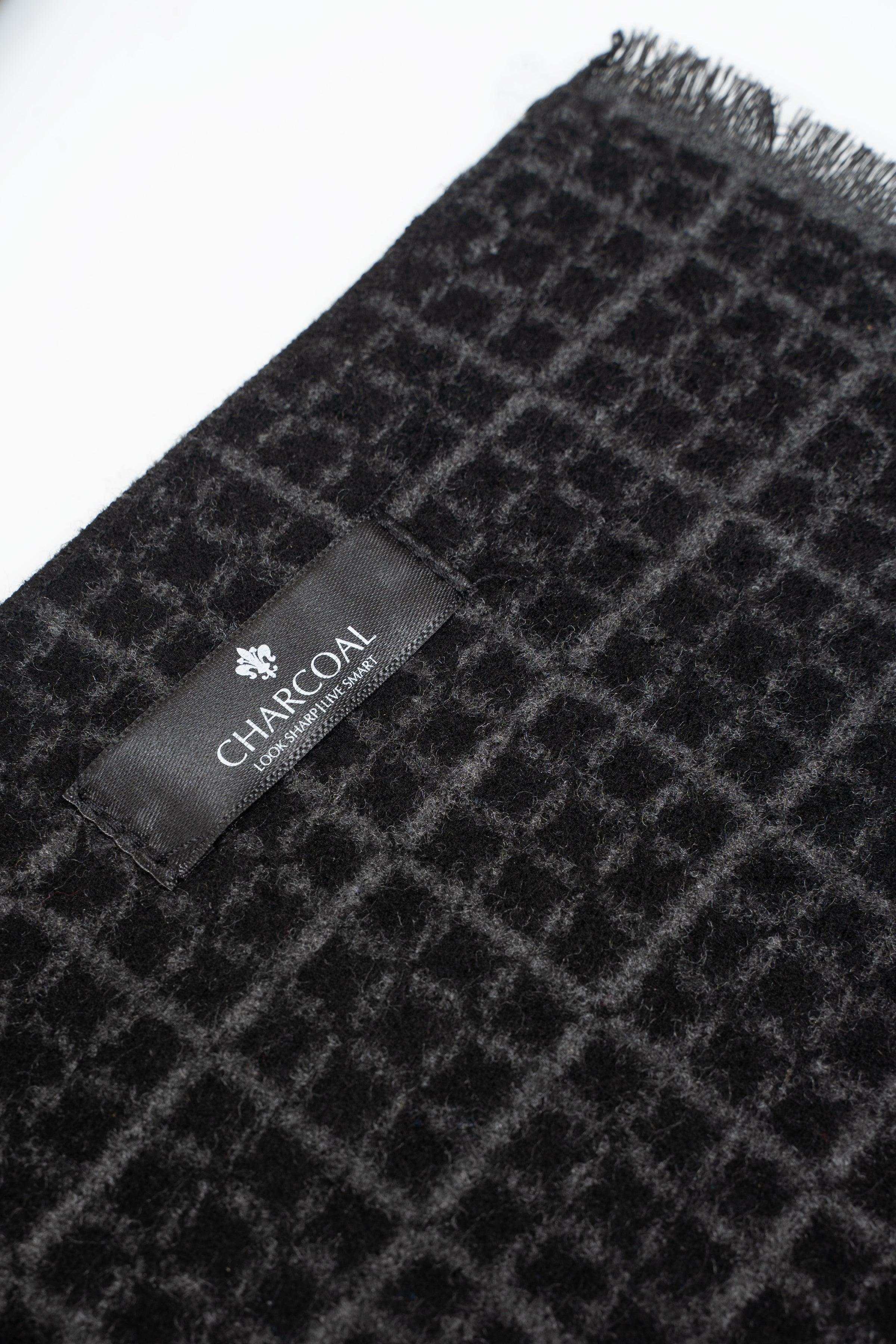 Dark charcoal scarf close-up with check pattern and 'CHARCOAL' tag.