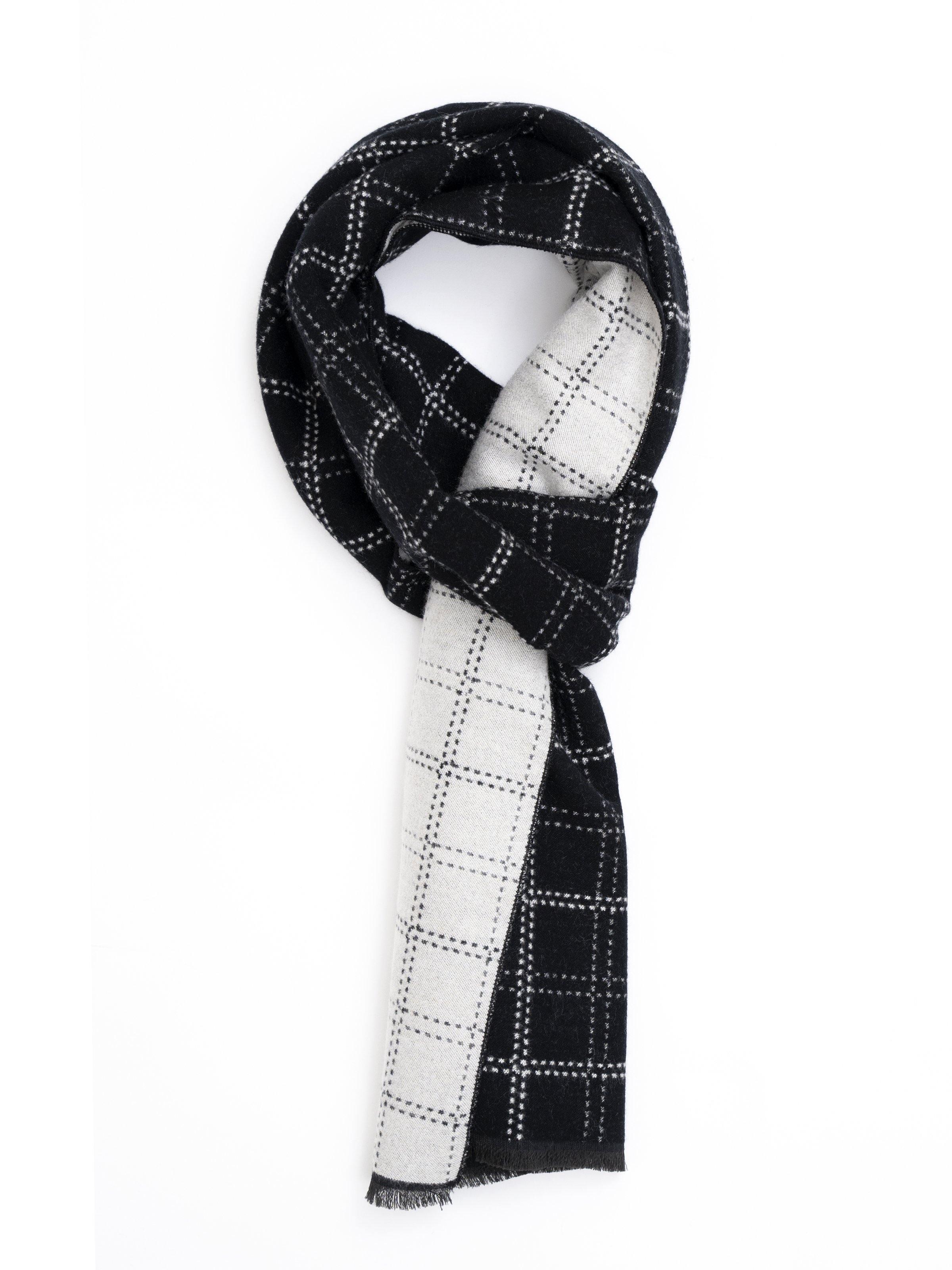 Scarf in black-and-white plaid with fringed ends, loosely draped.