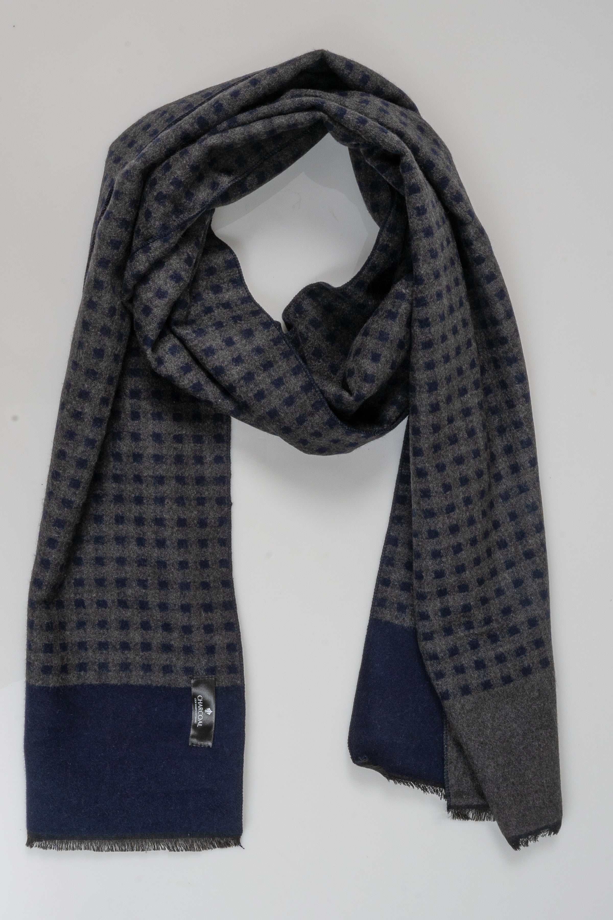 Draped dark check scarf with solid navy hem panel and fringed ends.