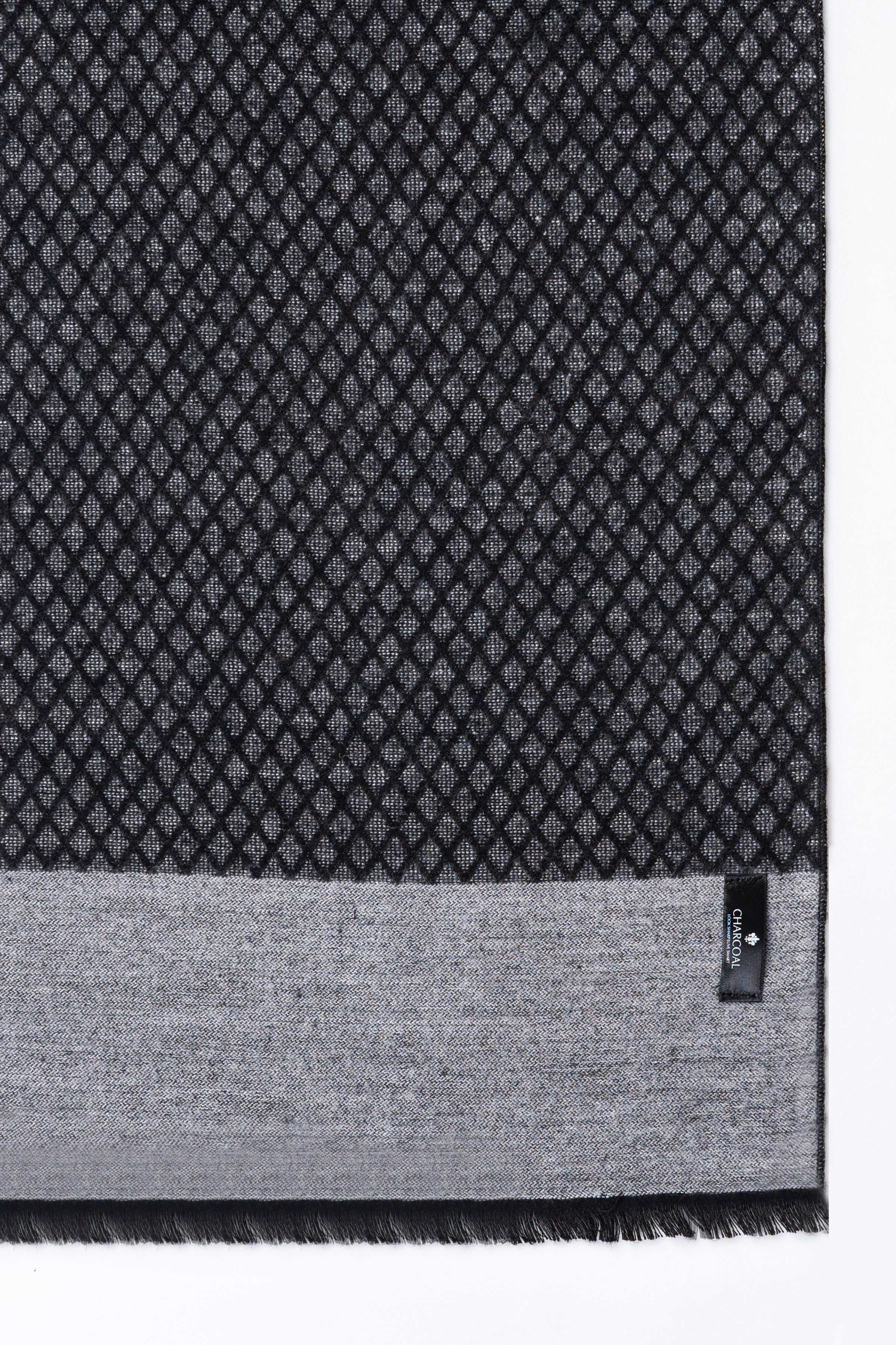 Black geometric-pattern scarf corner with gray border and stitched label
