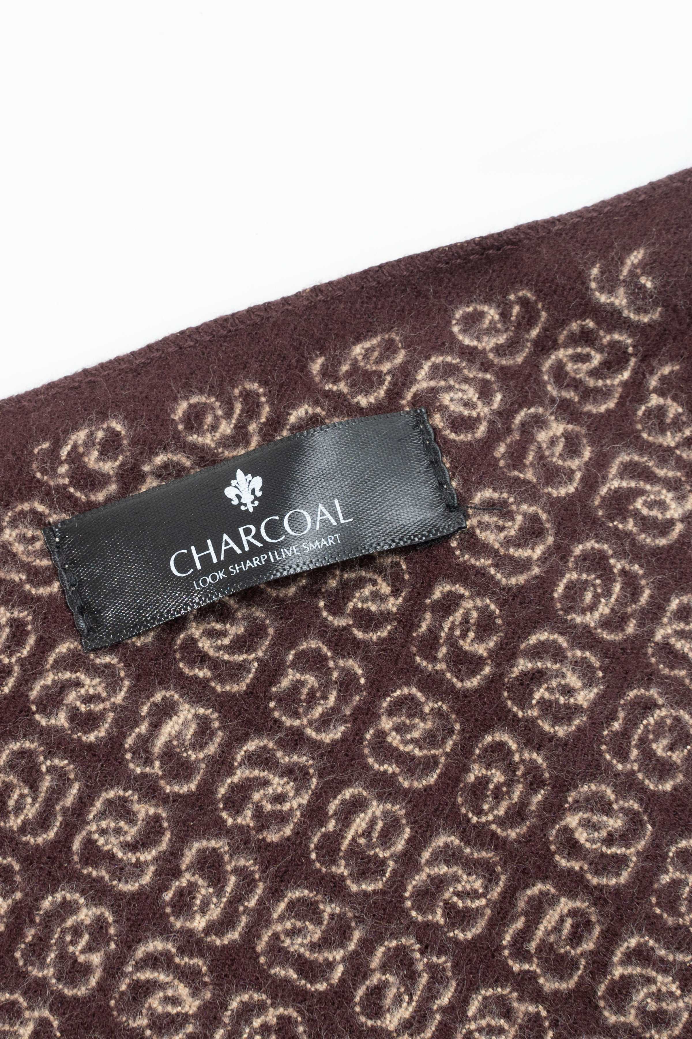 Maroon scarf fabric close-up with CHARCON logo label and repeating motif