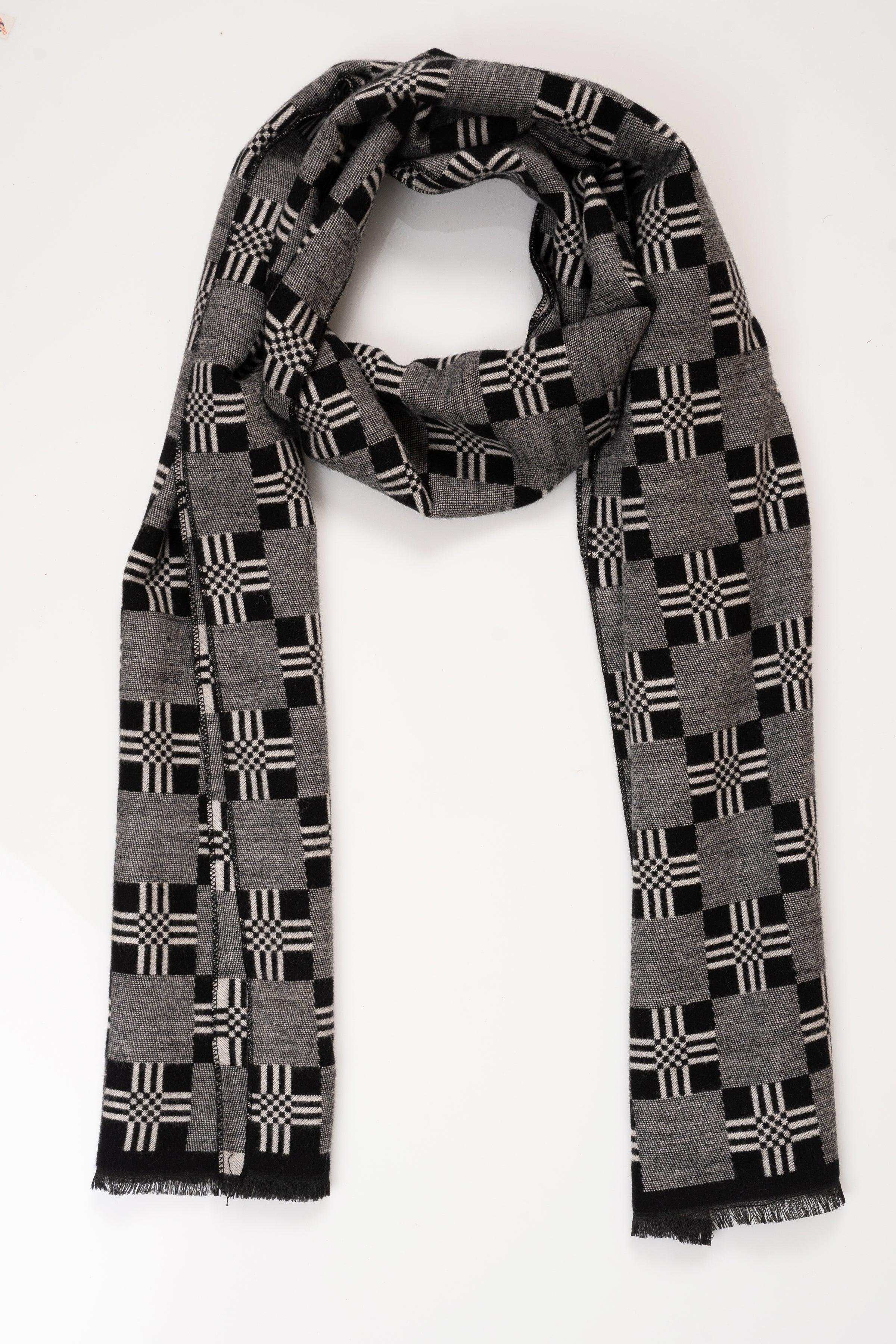 Dark gray plaid scarf draped in a loop, black and white check pattern, fringed.