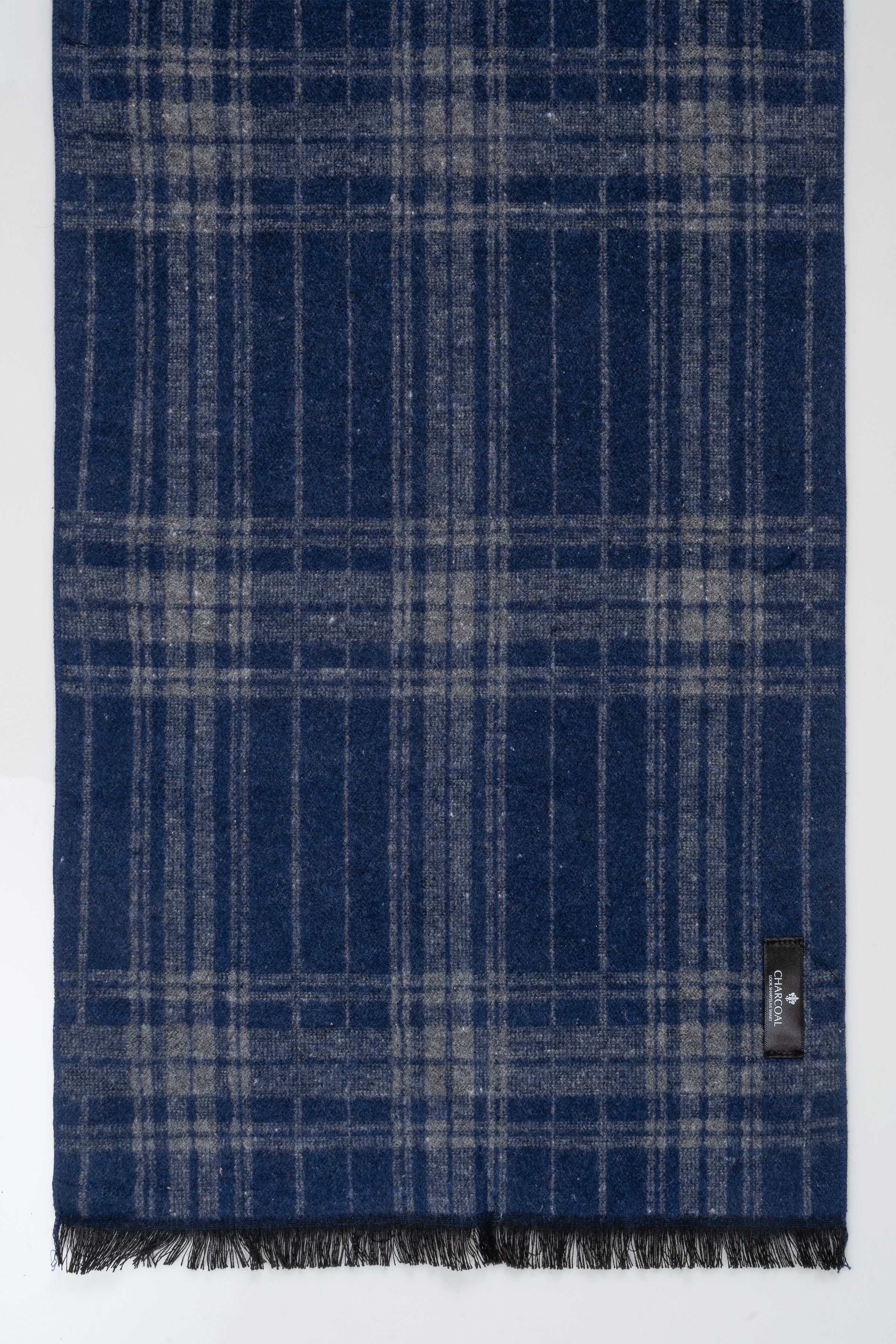 Blue plaid scarf with fringed border and small end tag