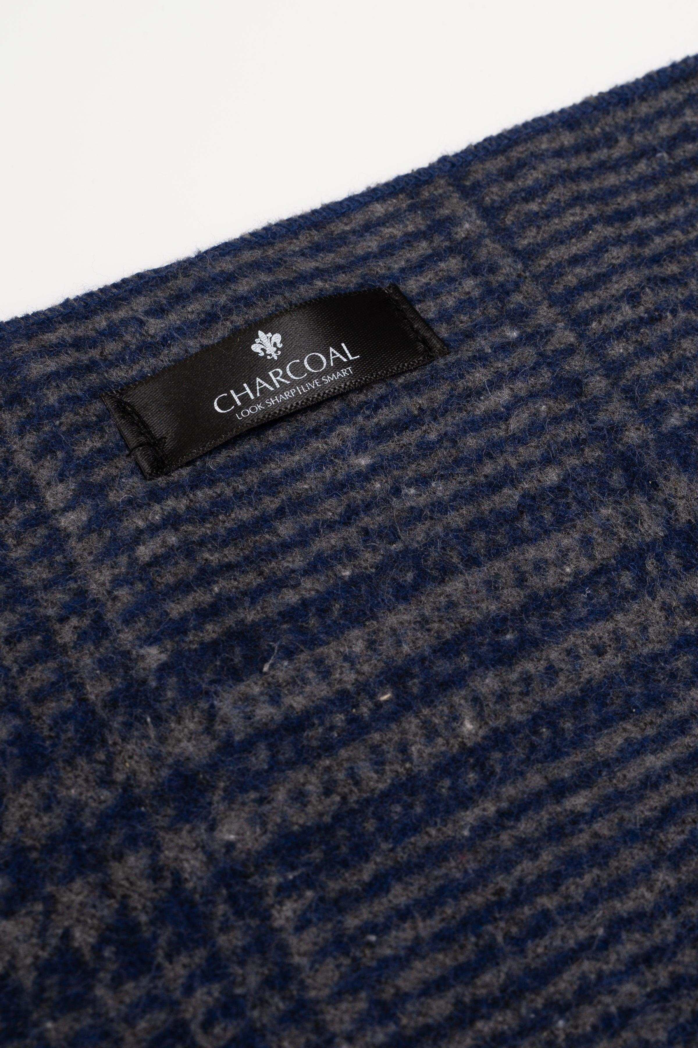 Charcoal label on dark plaid scarf with textured weave