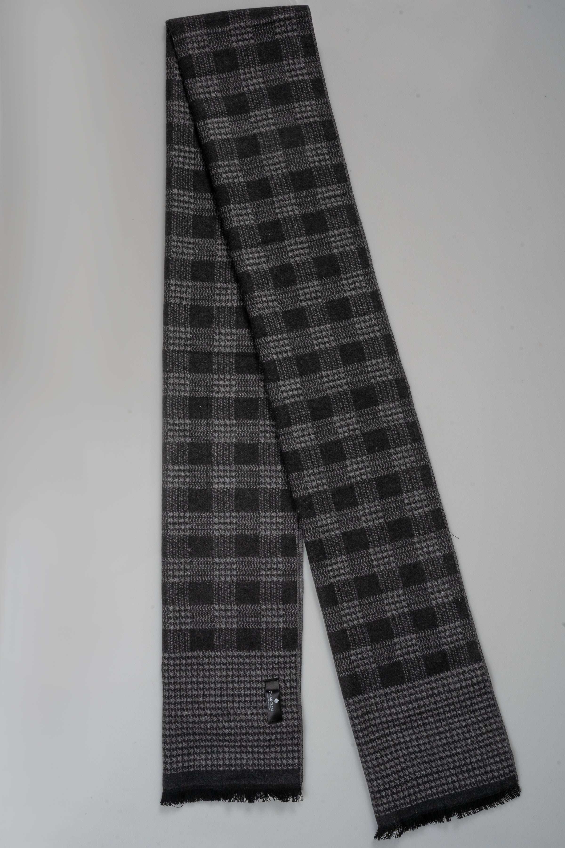 Plaid scarf in dark gray with light gray check pattern and fringed ends