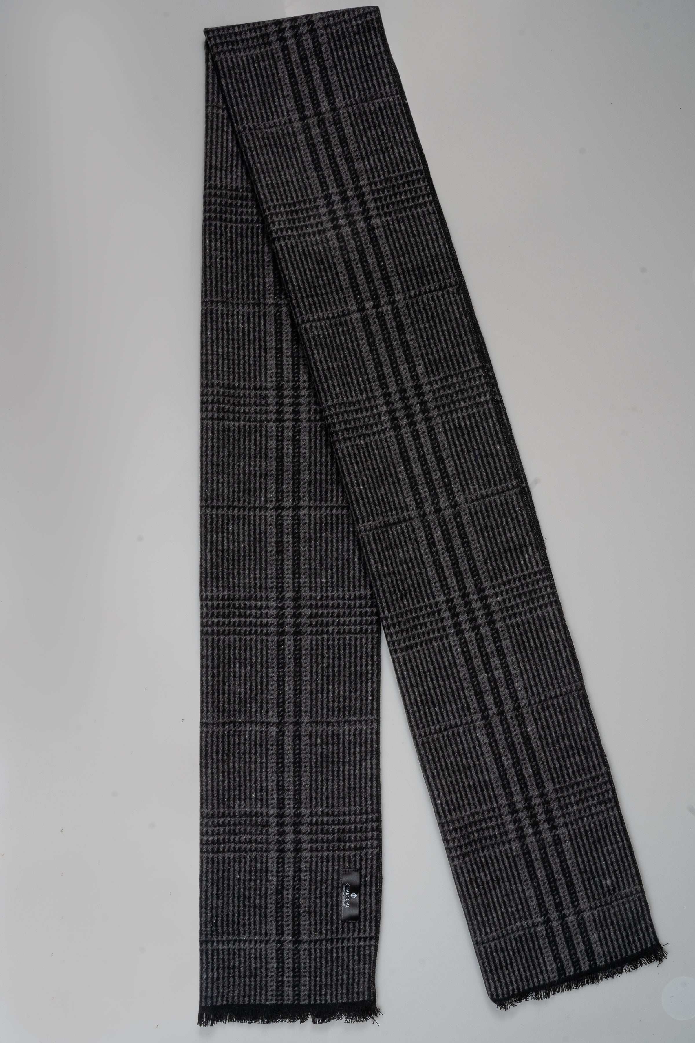 Charcoal plaid scarf with fringed ends and small logo tag