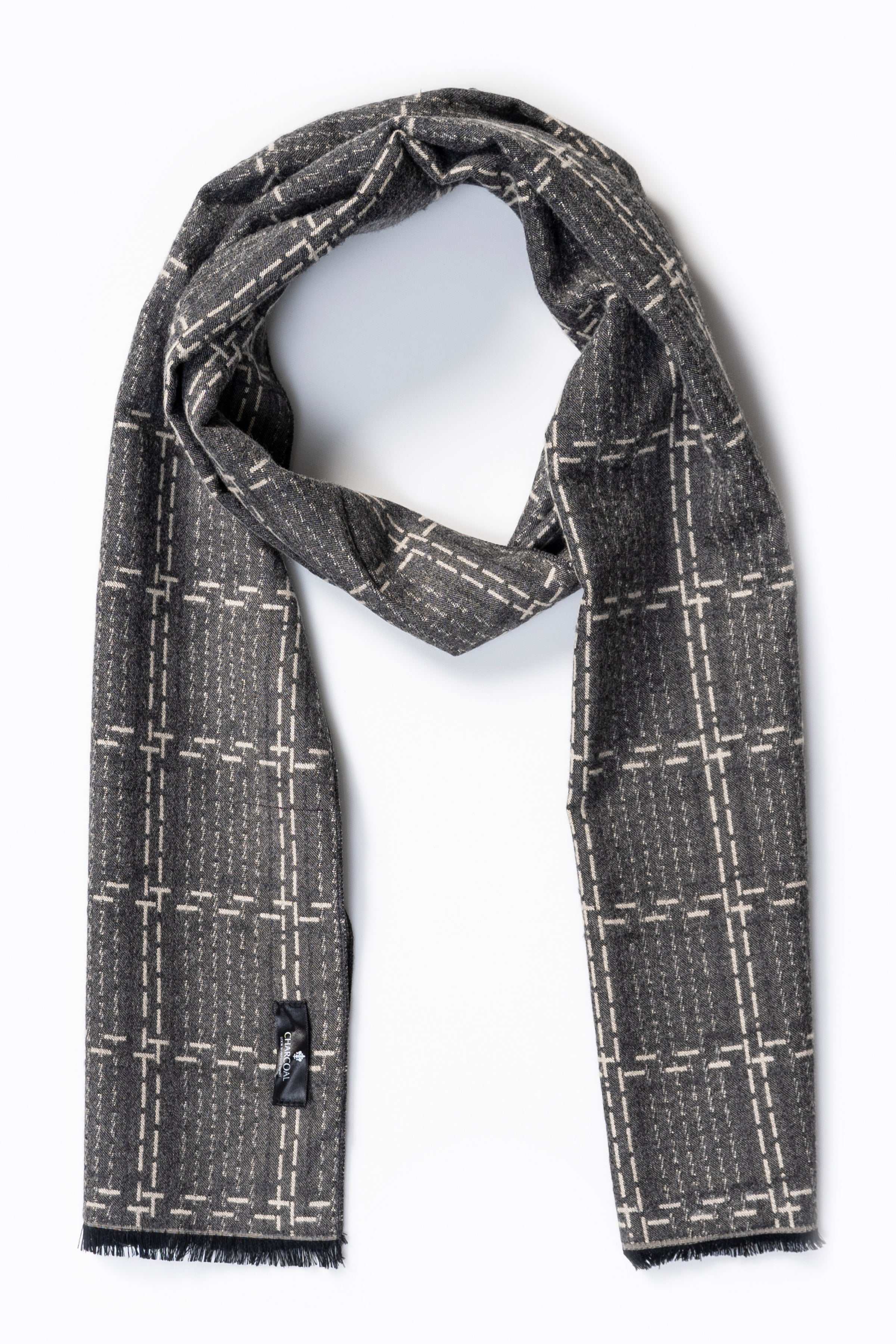 Dark gray woven scarf with light grid lines, draped and button detail on end.