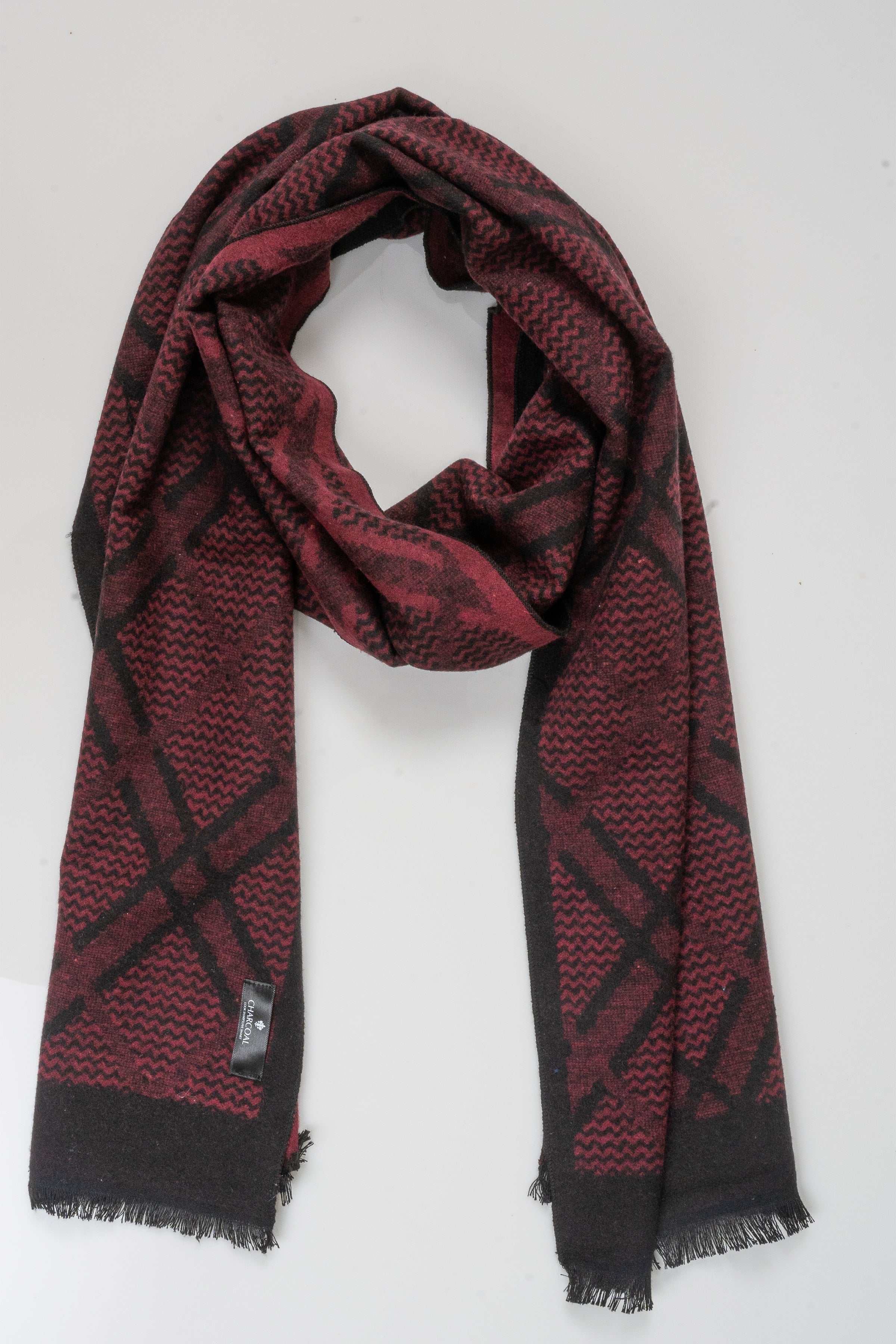 Burgundy scarf with black geometric pattern and fringed ends