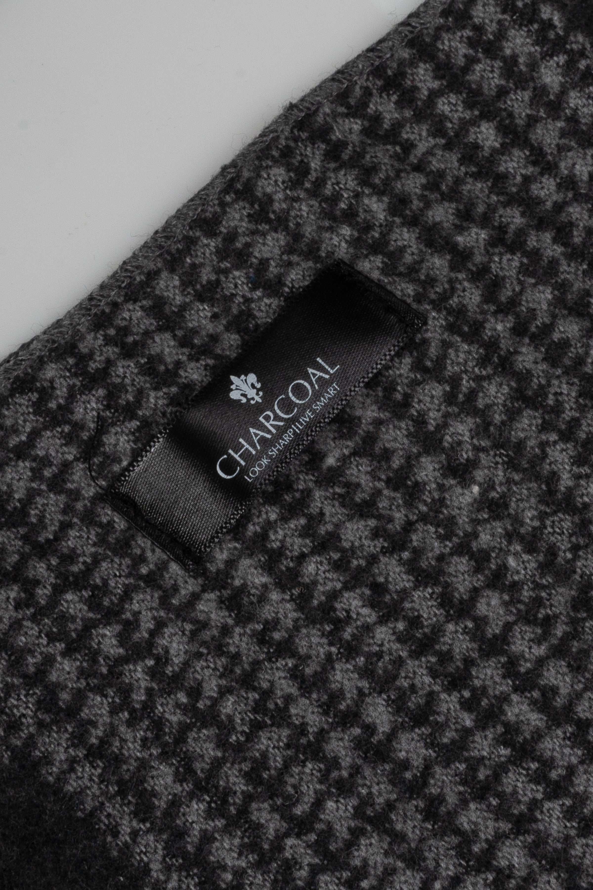 Plaid scarf with embroidered brand tag on dark gray check fabric