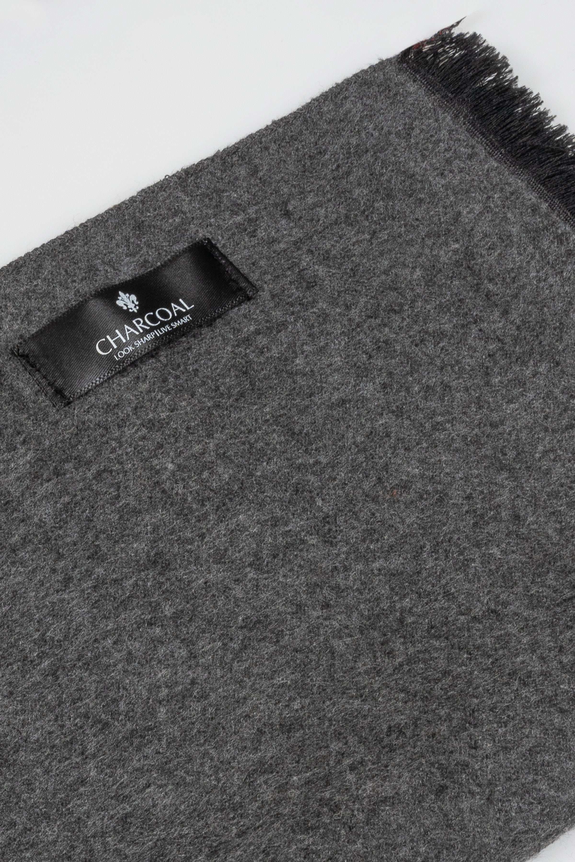Charcoal gray scarf fabric close-up with rectangular CHARCOAL label