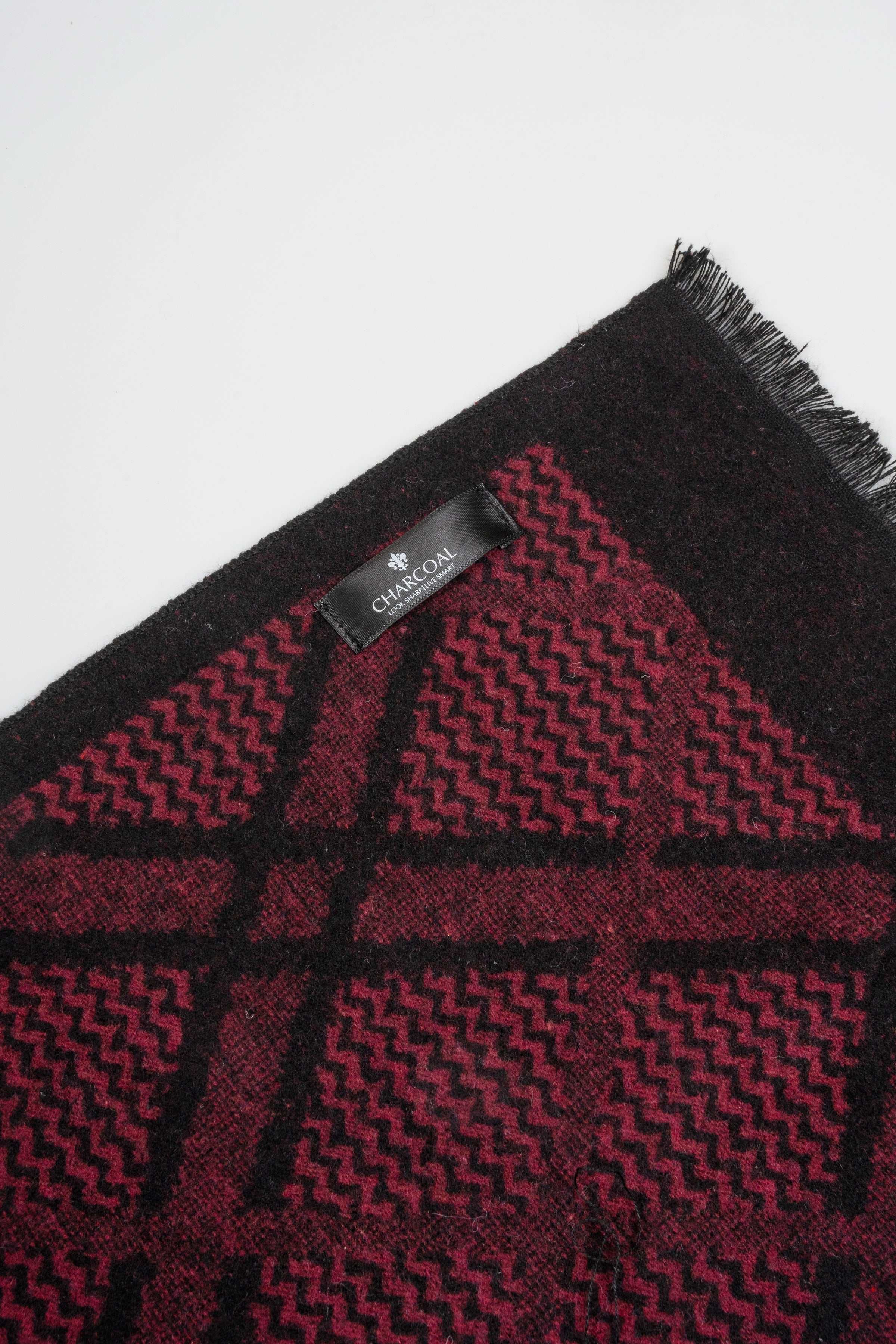Burgundy scarf with black geometric motif and short fringes; brand label