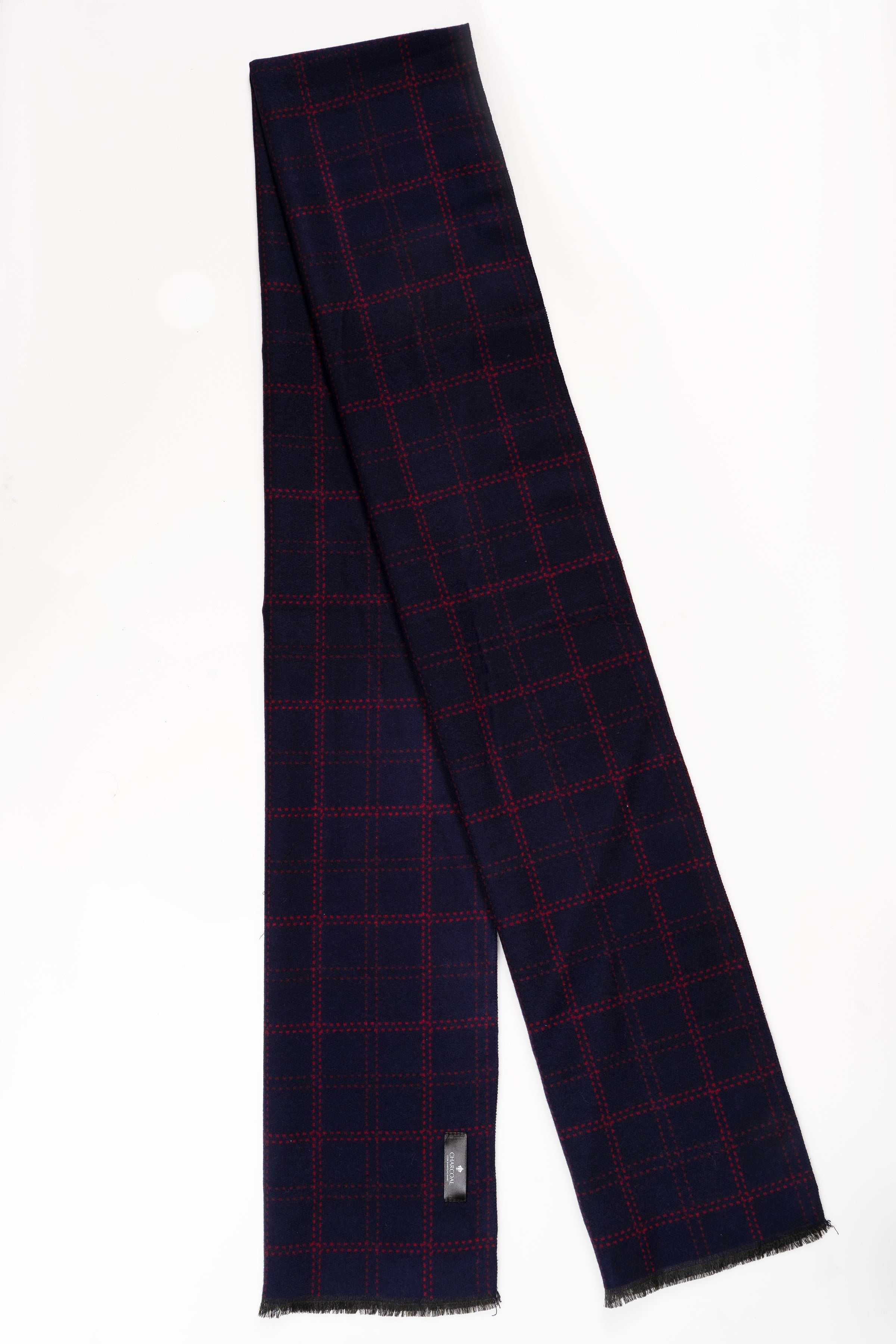Navy plaid scarf with red grid, fringed ends and folded drape