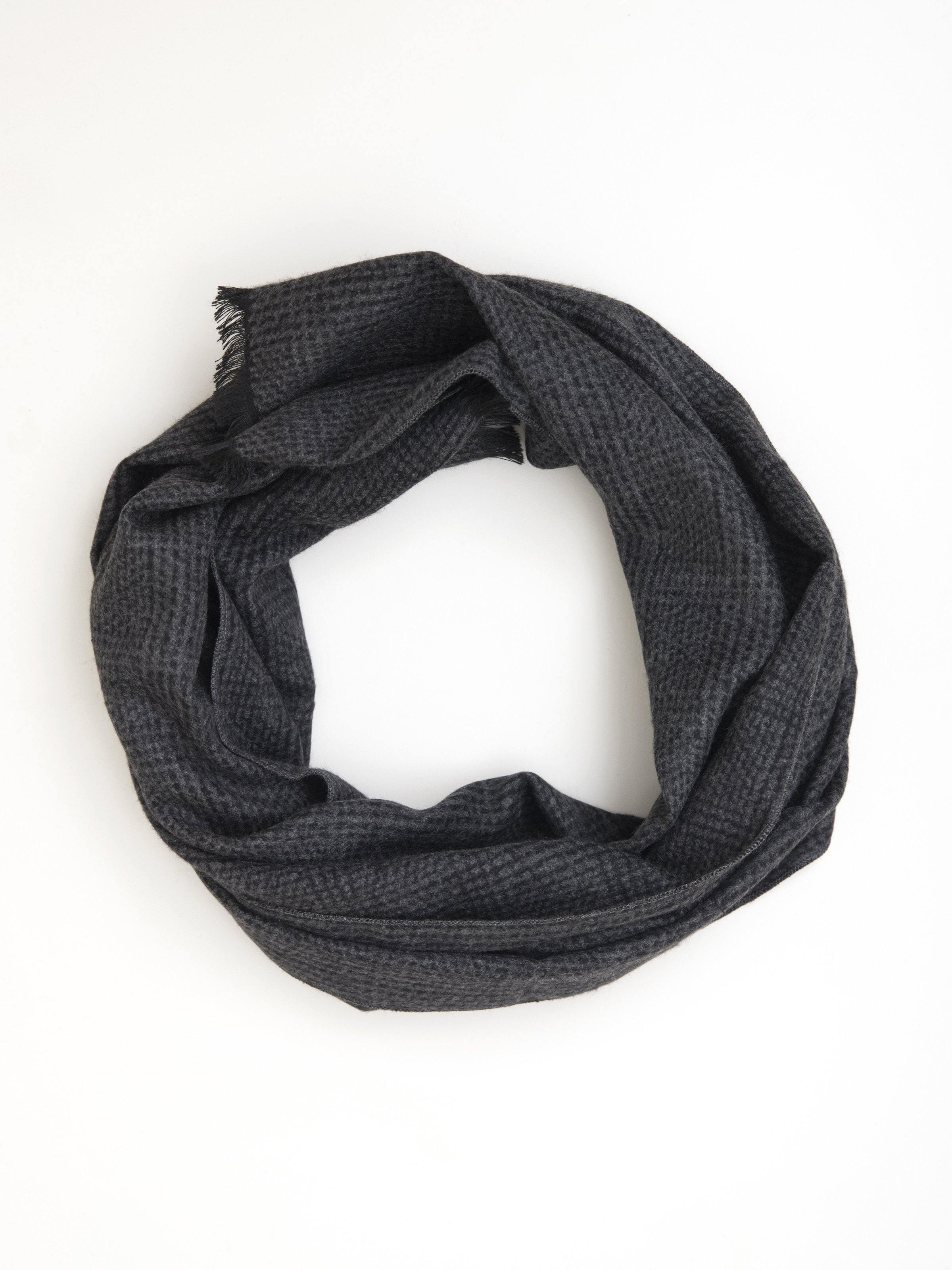 Dark gray woven scarf with subtle pattern and soft drape