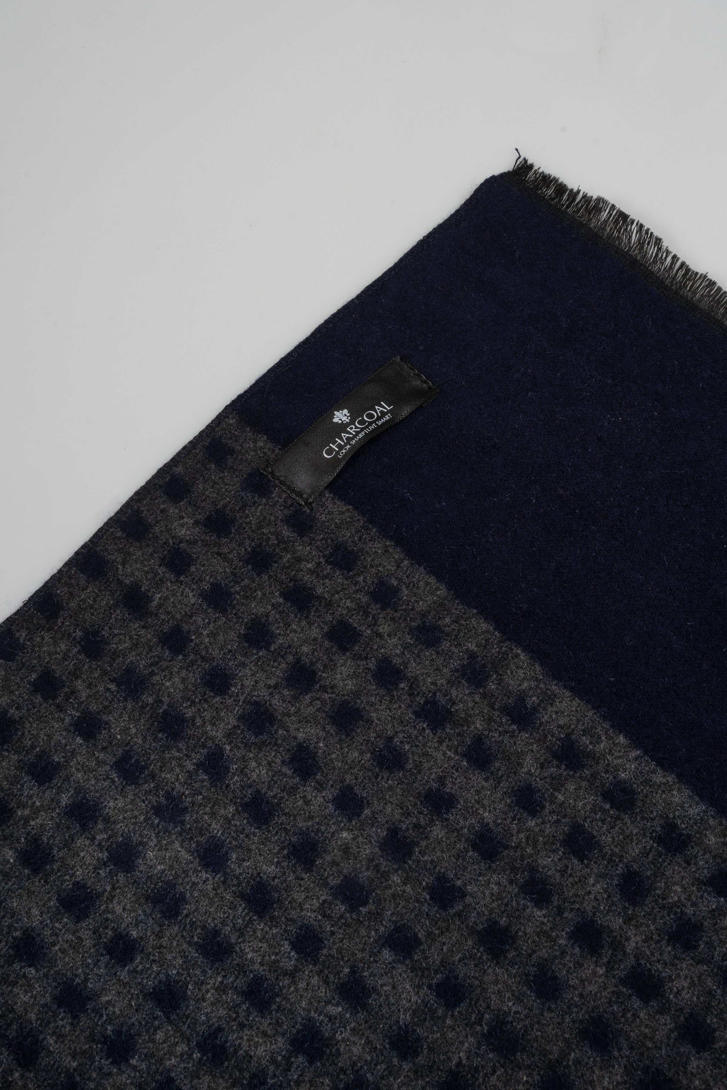 Navy check-pattern scarf with repeating texture and small logo label near edge.
