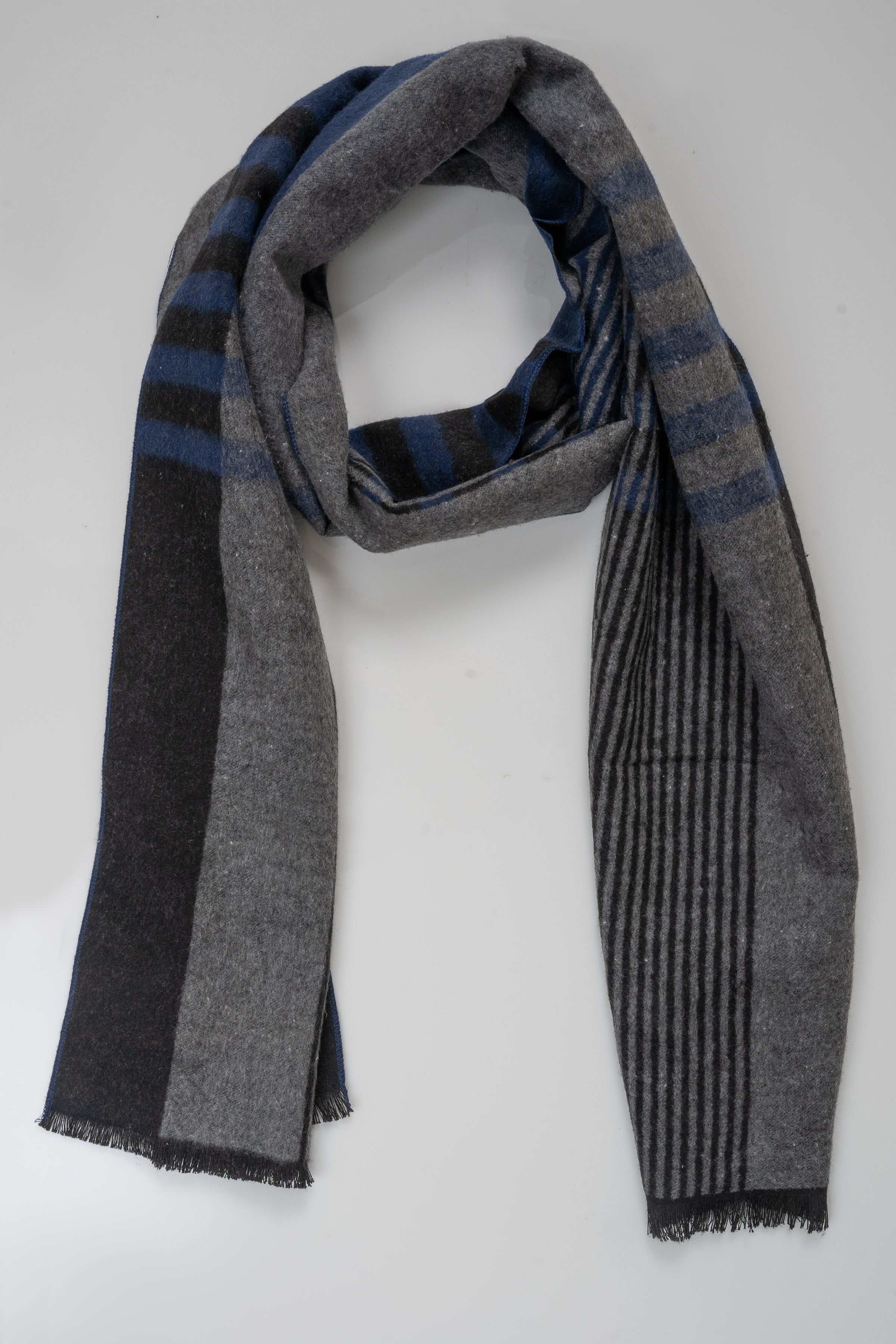 Plaid scarf in dark gray and blue with fringe ends, woven pattern.