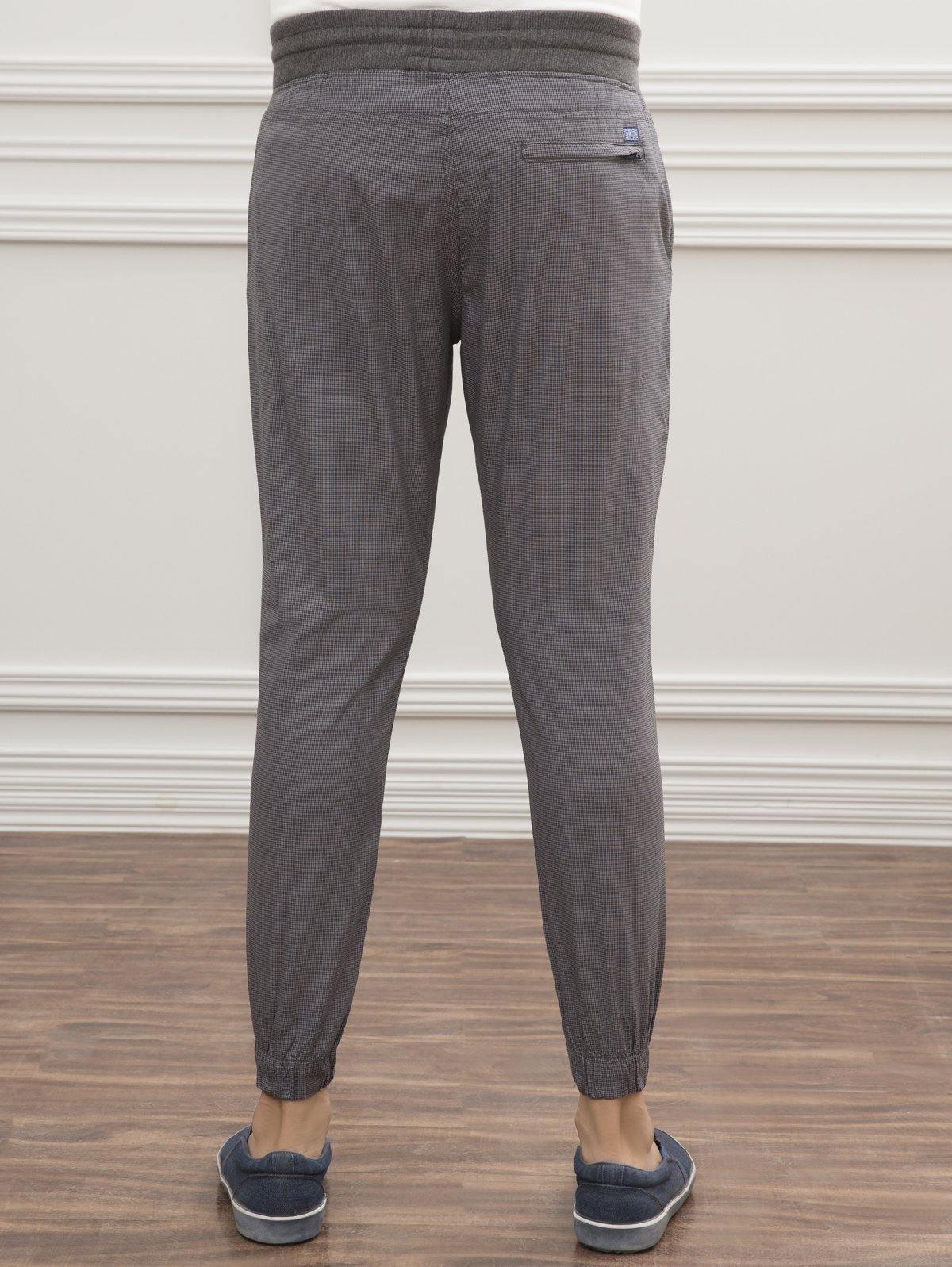 Grey slim-fit trousers with drawstring waist and elastic cuffs, rear view