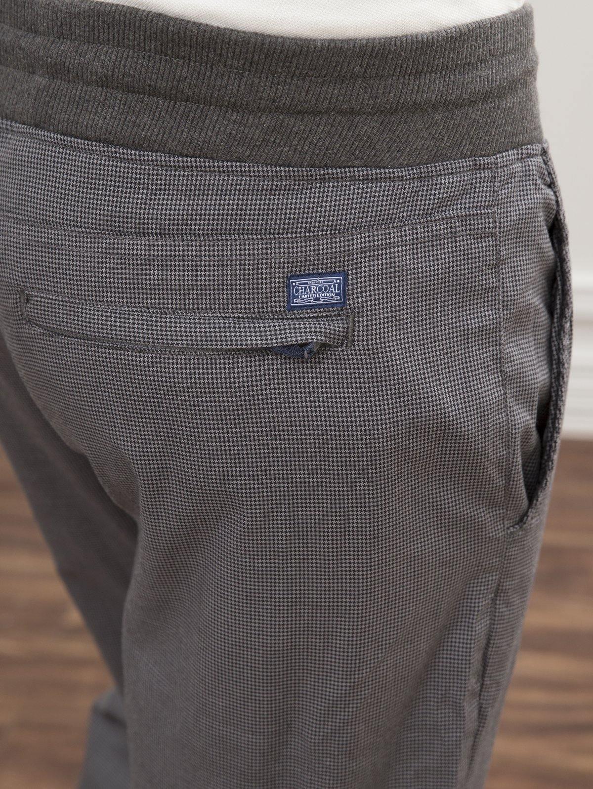 Grey slim-fit trousers detail: logo patch on pocket