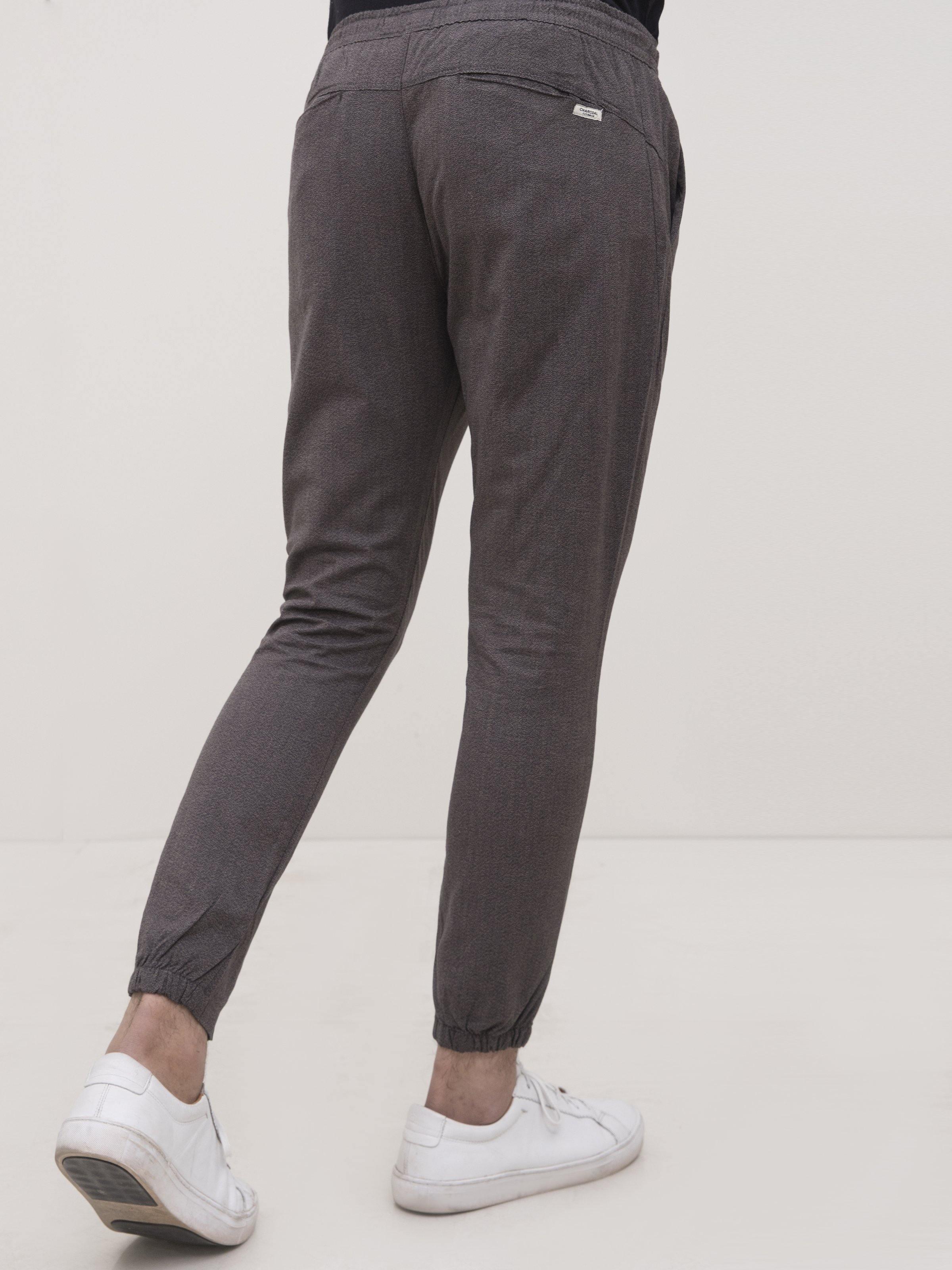 Dark gray tapered trousers with ankle cuffs and slanted side pockets
