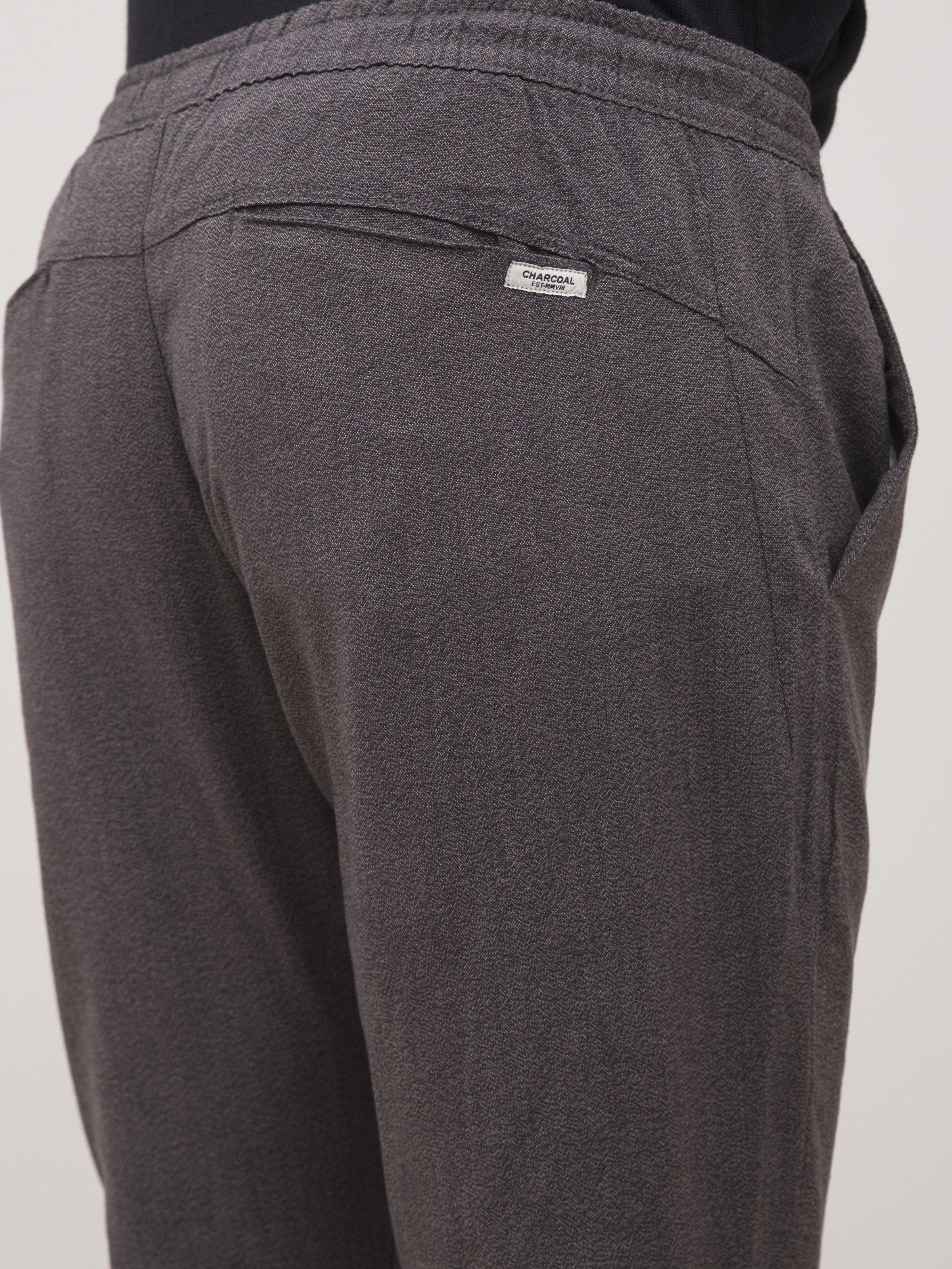 Dark gray back tapered trousers with logo patch and yoke seam