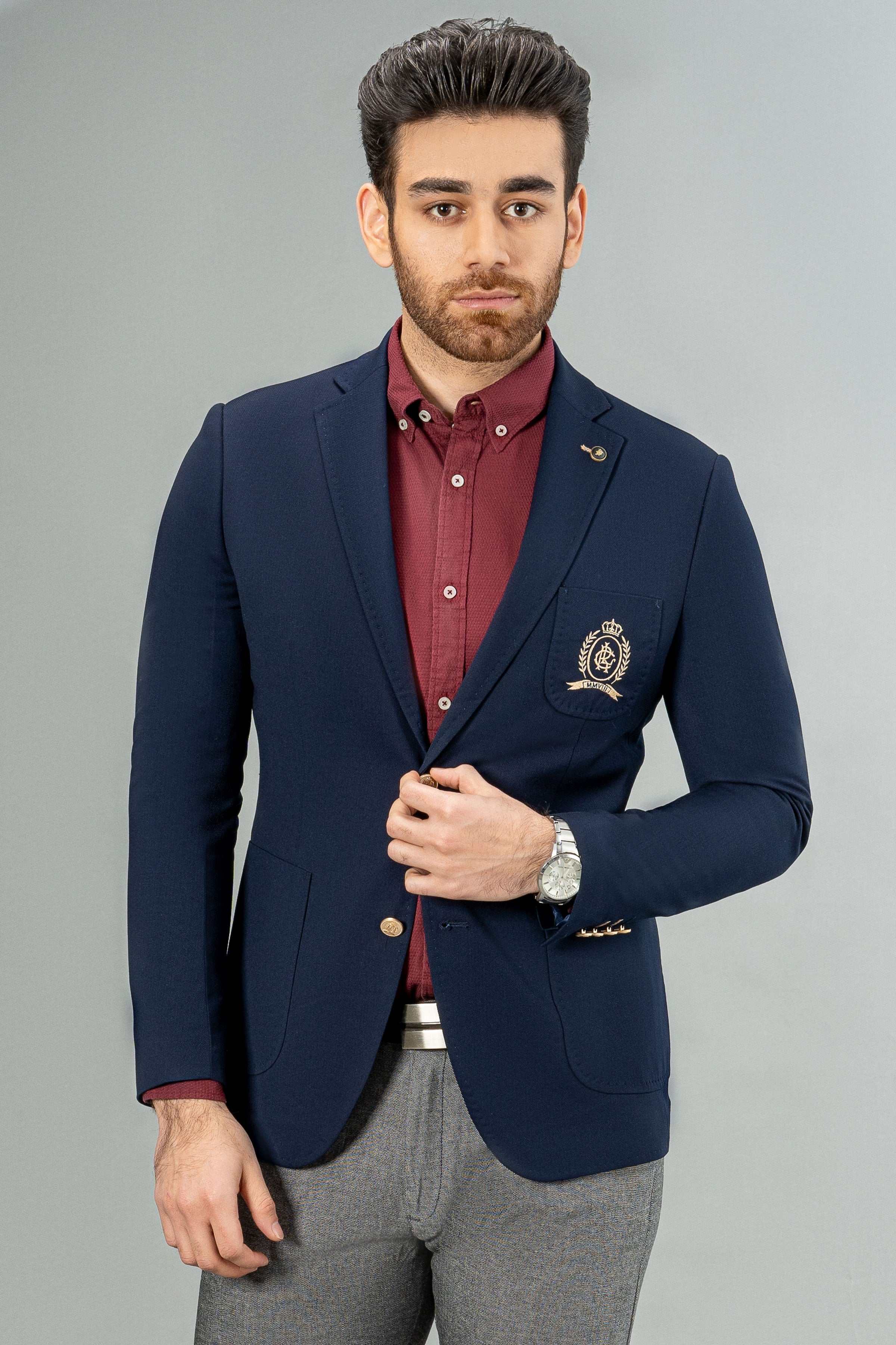 Navy casual blazer-style coat with crest pocket and gold buttons, worn with burgundy shirt