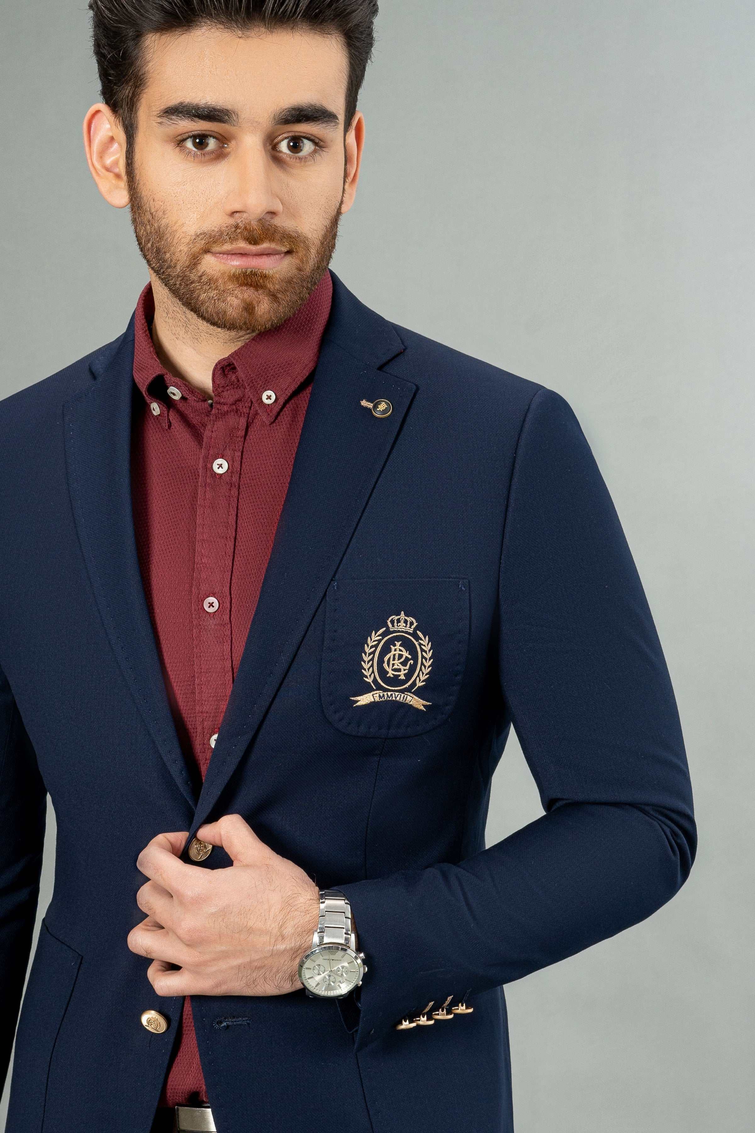 Navy casual coat with crest pocket, gold front buttons, and tailored notch lapels