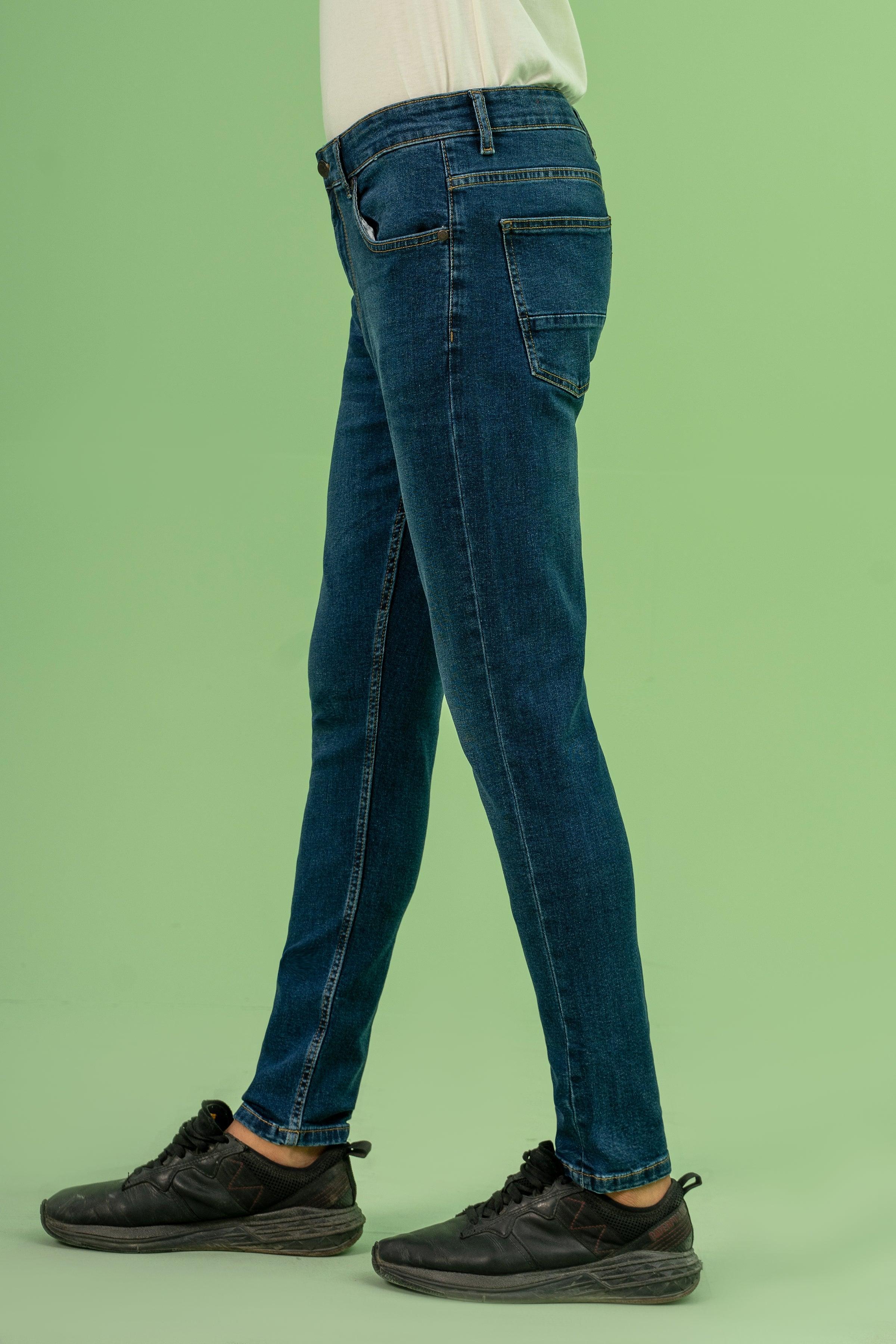 Skinny leg dark blue denim jeans, side view with belt loops and slim straight fit
