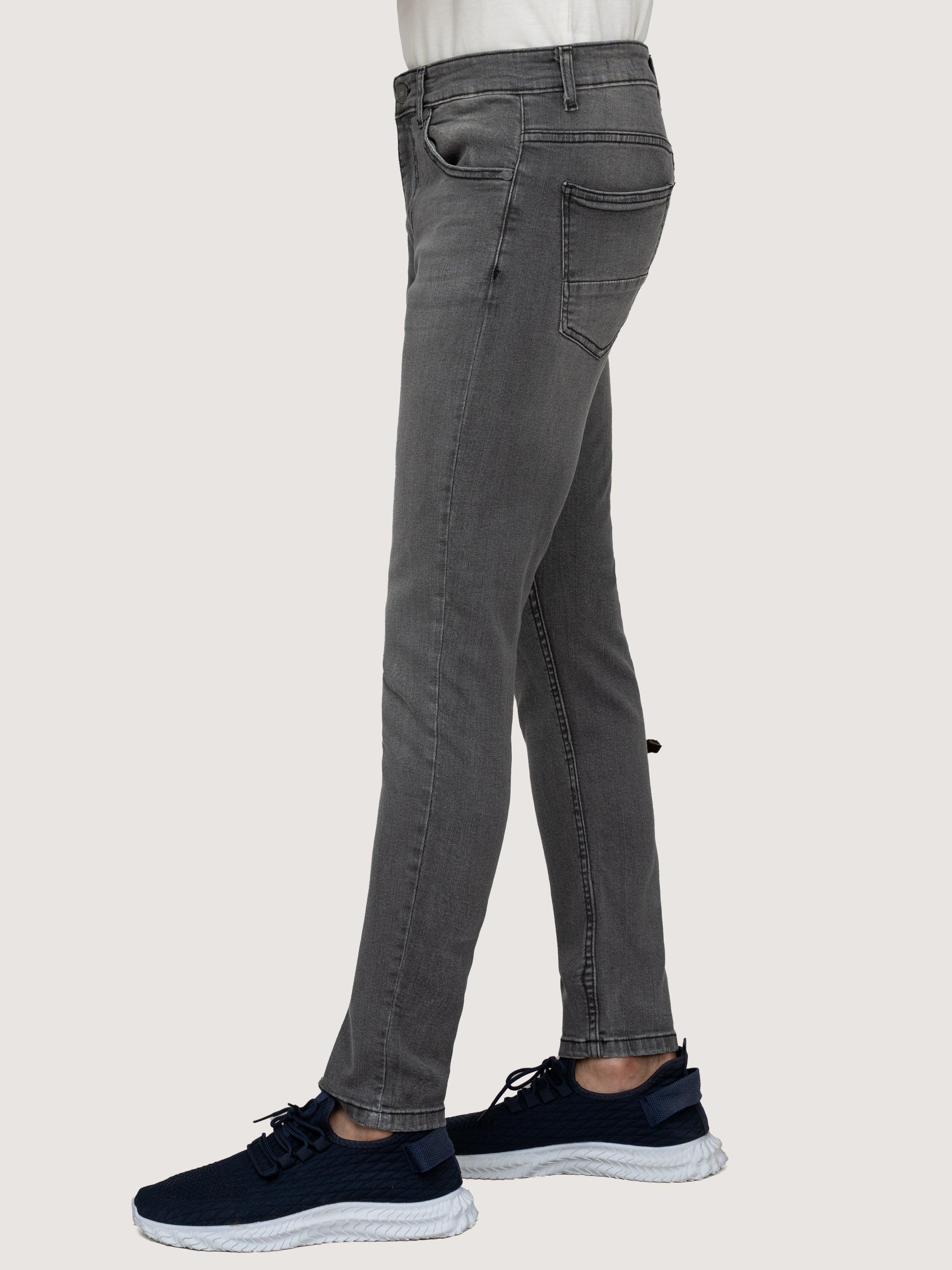 Grey stone-wash skinny jeans, back view with rear pockets and belt loops