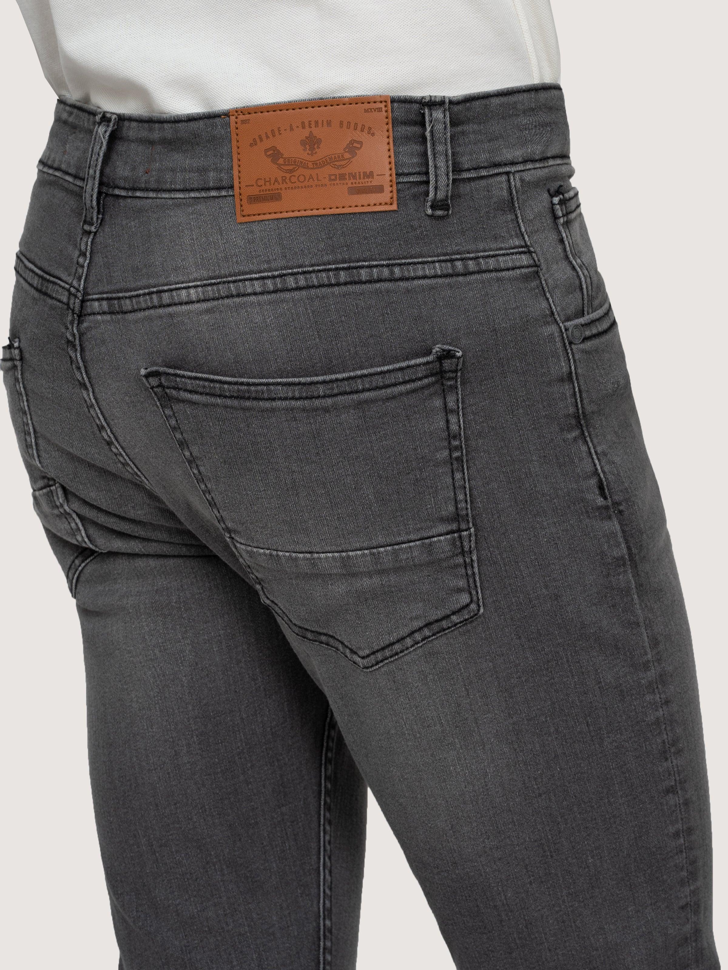 Grey stone-wash skinny jeans close-up of front pocket and curved stitching