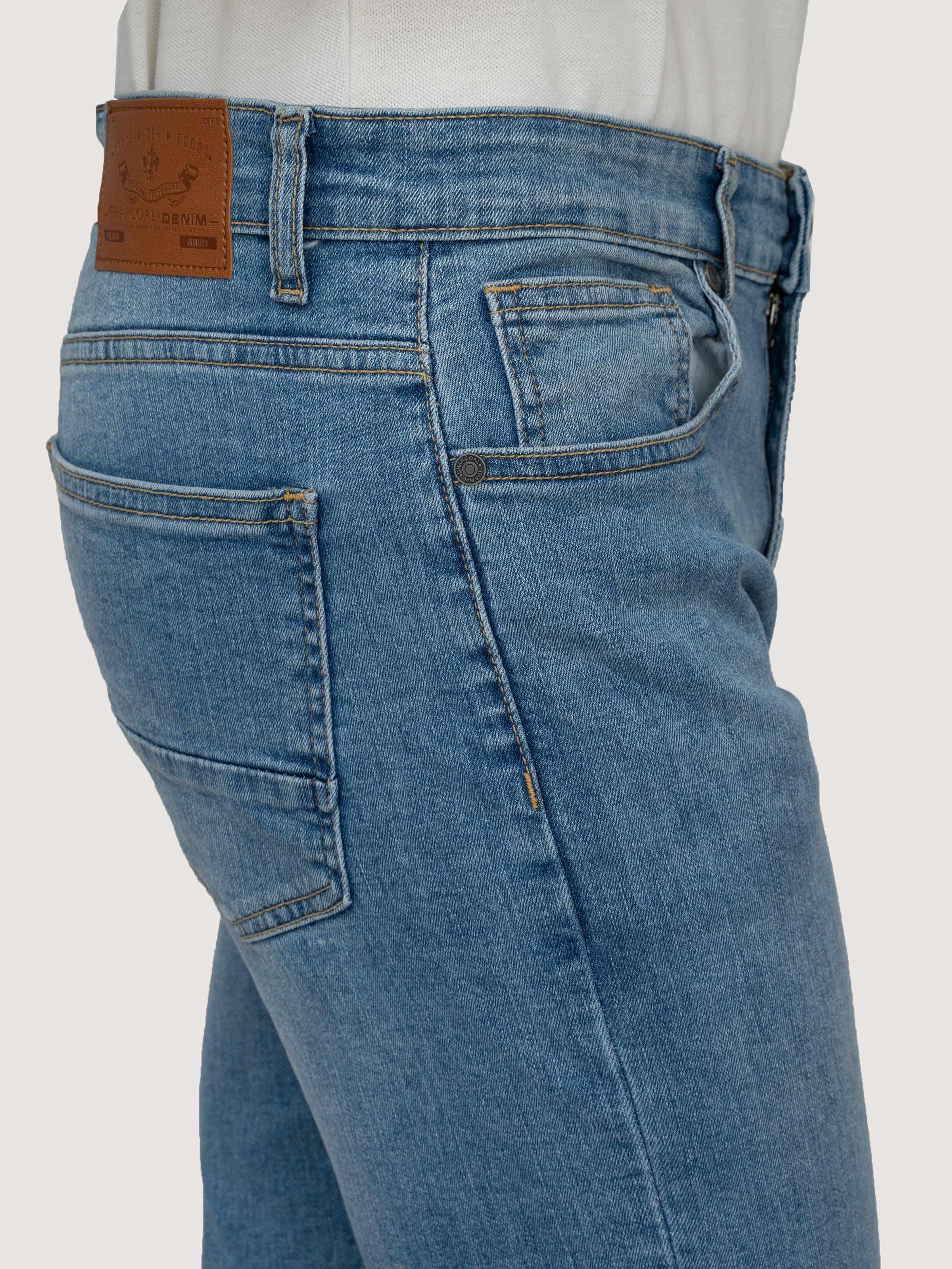 Light blue denim jeans close-up of rear pockets and stitched waistband